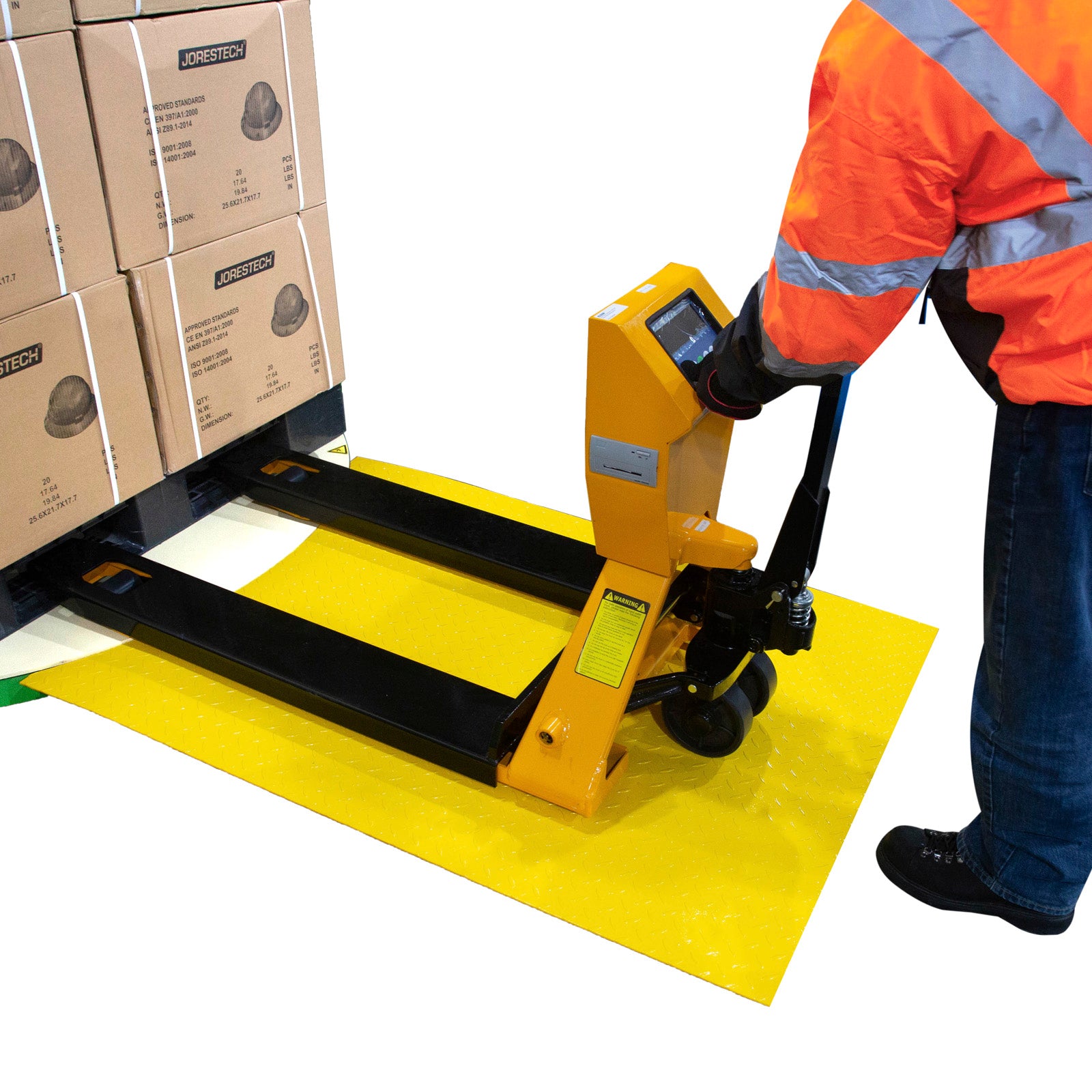  Man wearing a high-vis orange jacket pushing a pallet jack loaded with boxes through the loading ramp and onto the stretch wrapper.