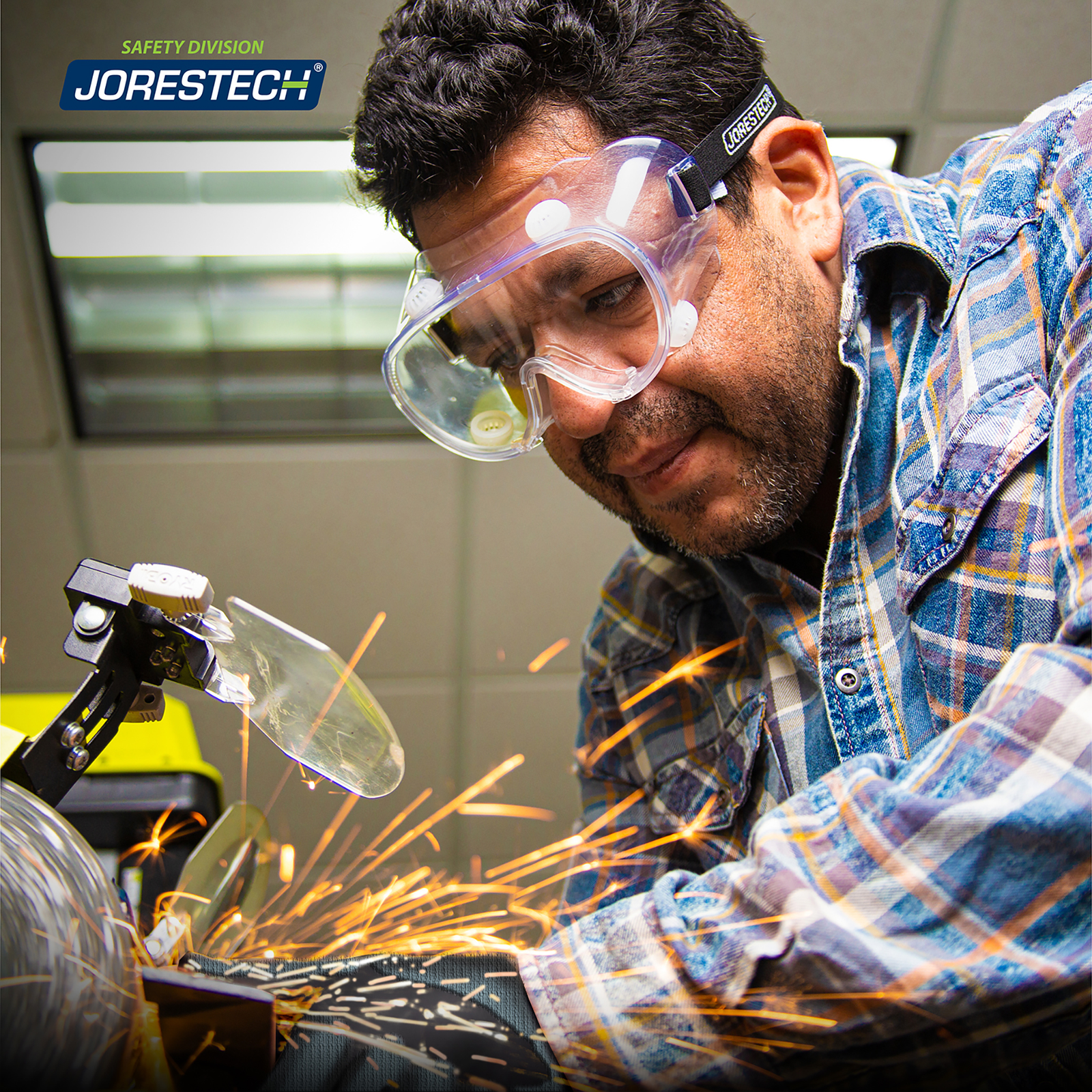  Man wearing JORESTECH safety goggle while operating a power tool machine