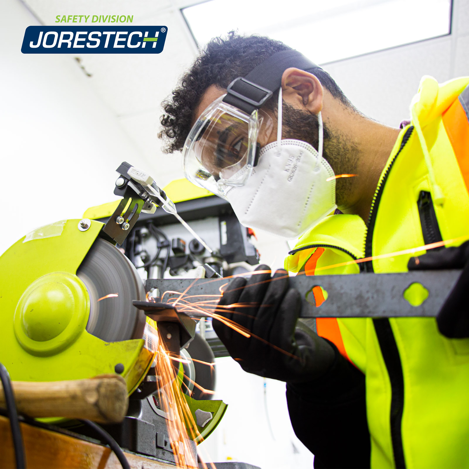 A mechanic wearing JORESTECH safety goggle while operating a power tool machine