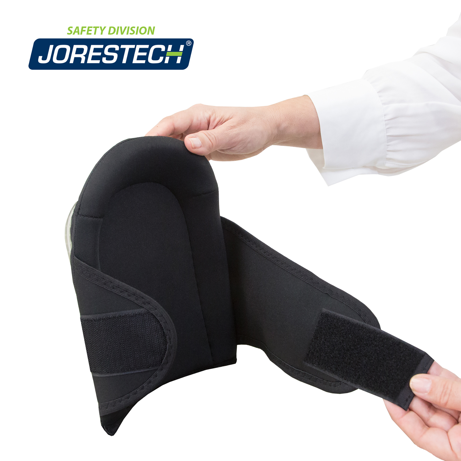 Two hands of a person pulling open the strap of the heavy duty JORESTECH knee pad