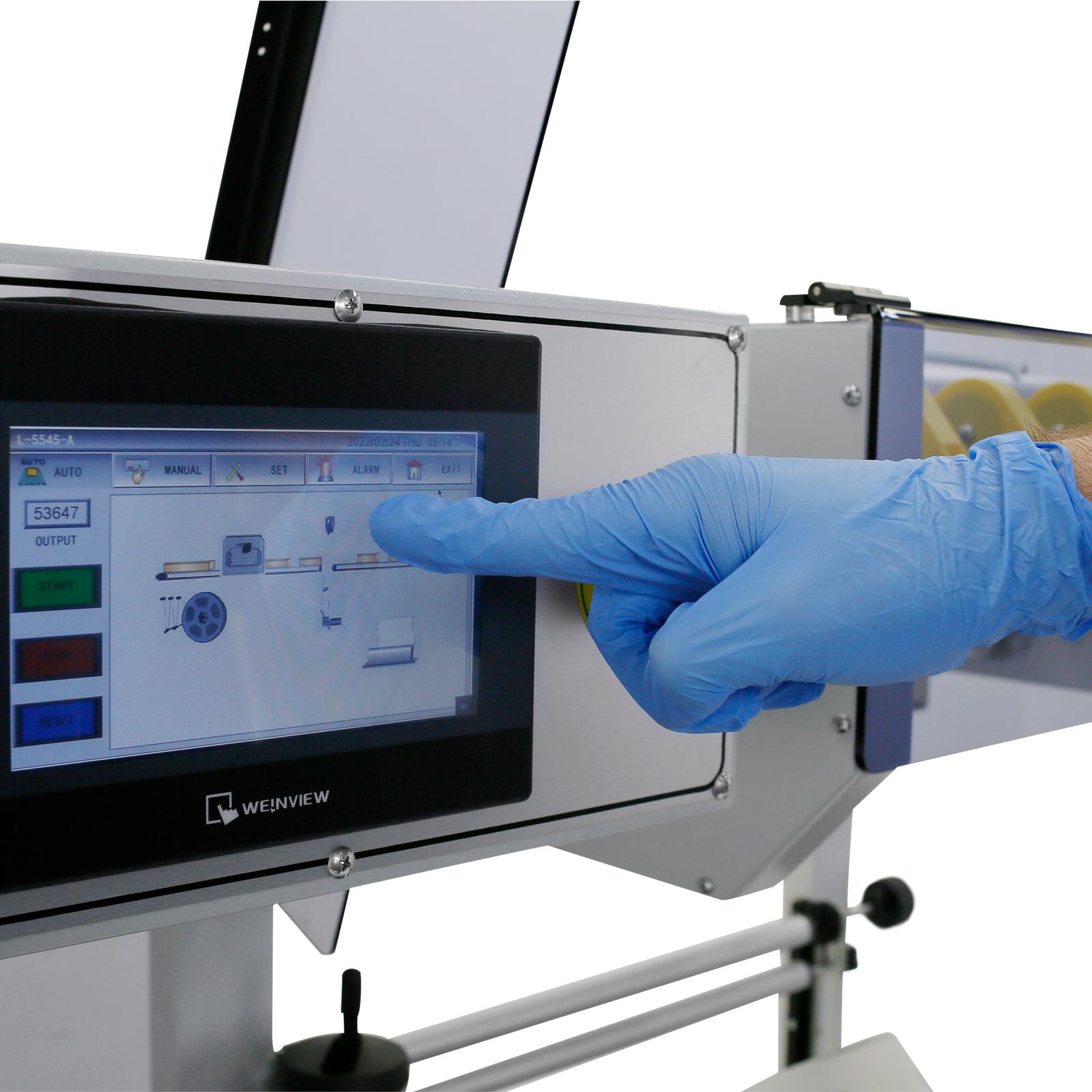 Close up shows the hand of a person touching the touchscreen panel of the JORESTECH Automatic L Bar Film Sealer to set it before stating production.