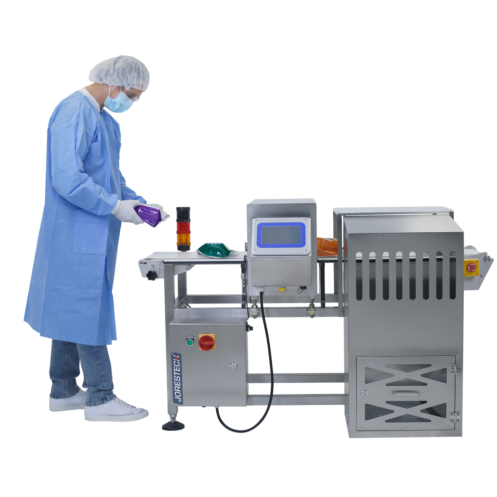 operator wearing blue protective overall and white hairnet placing bags on steel JORES TECHNOLOGIES® automatic metal detector with white conveyor