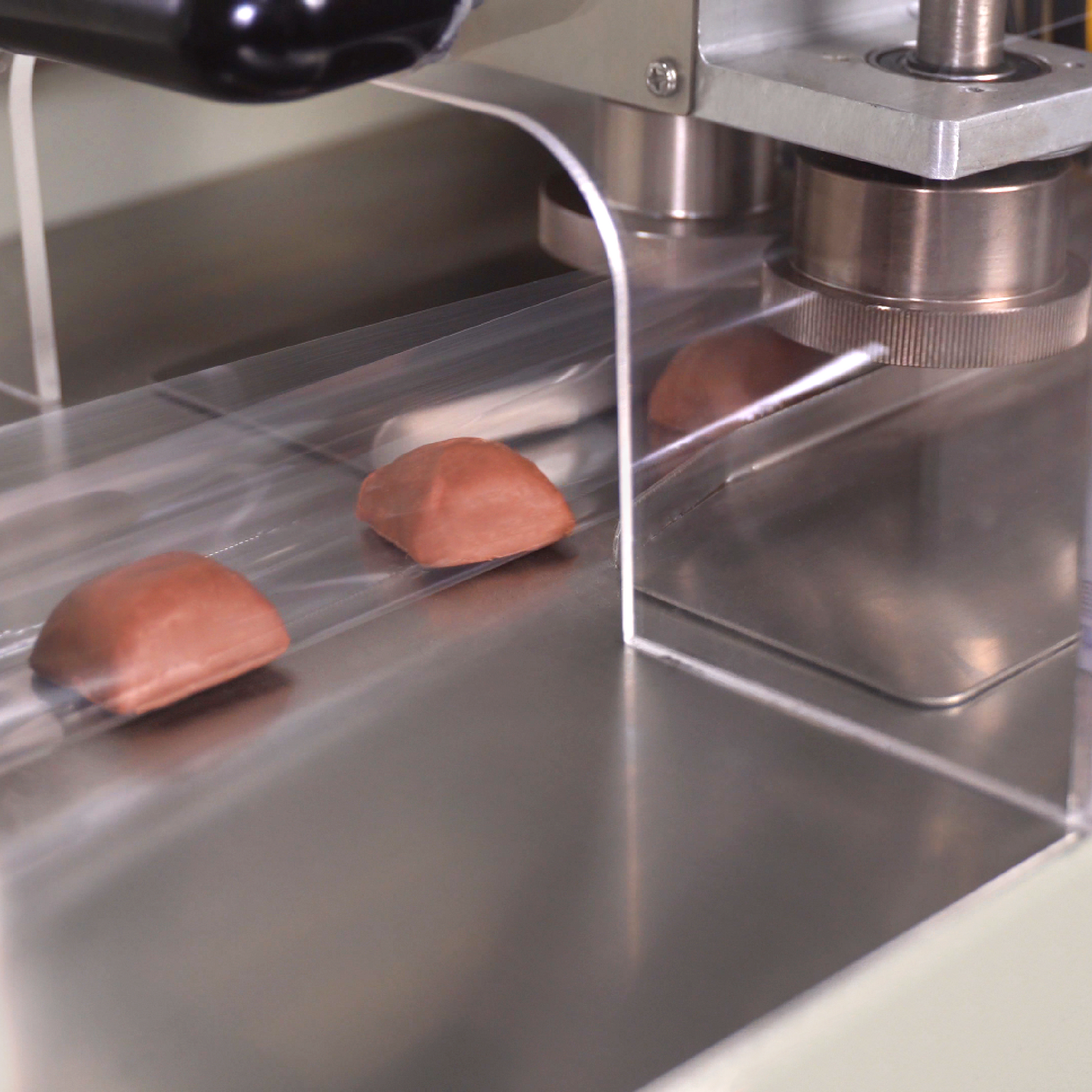 Insertion of small candies into a form and seal machine for forming pillow bags