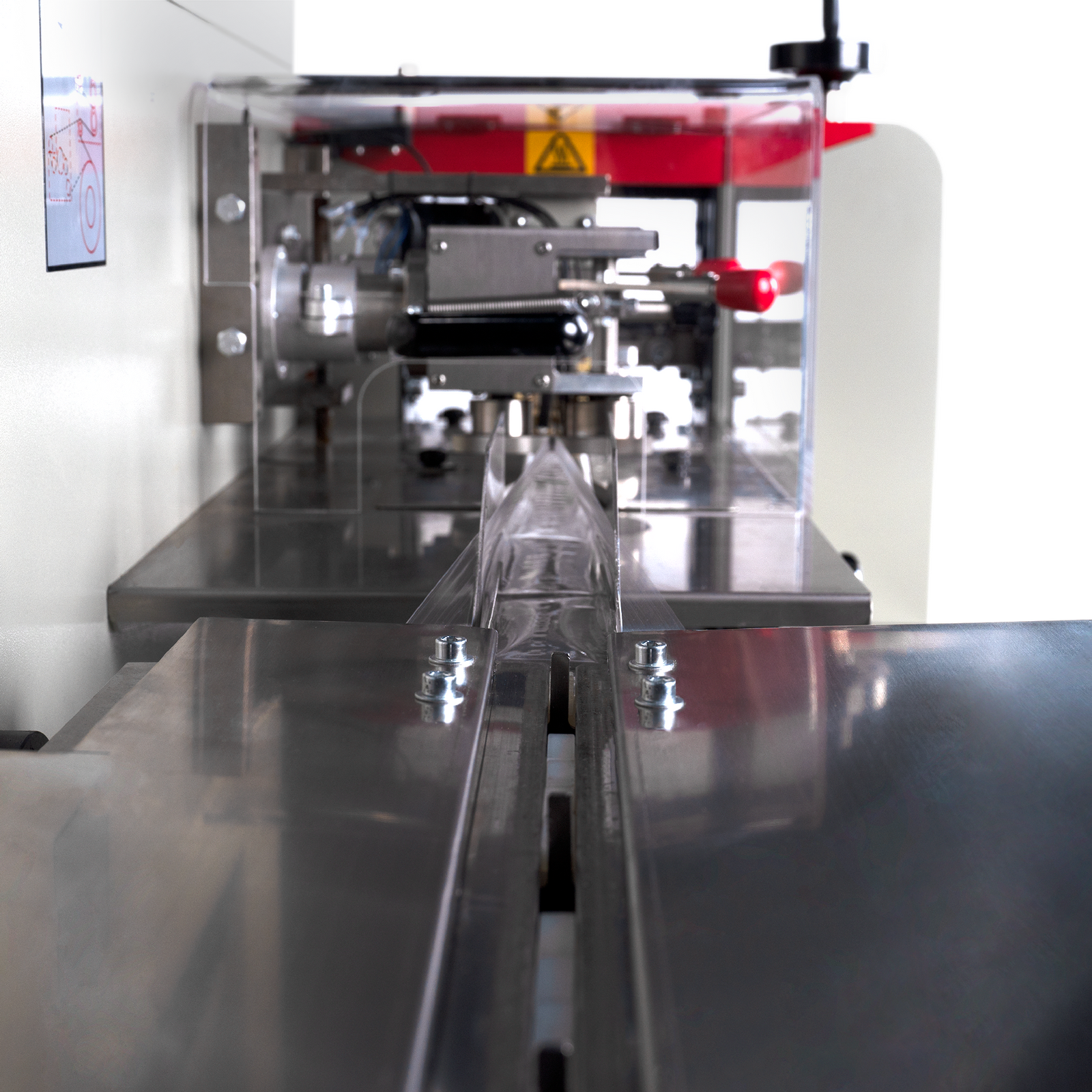 Close-up of the bag forming process done by a automatic horizontal flow wrapper with inverted film feeder