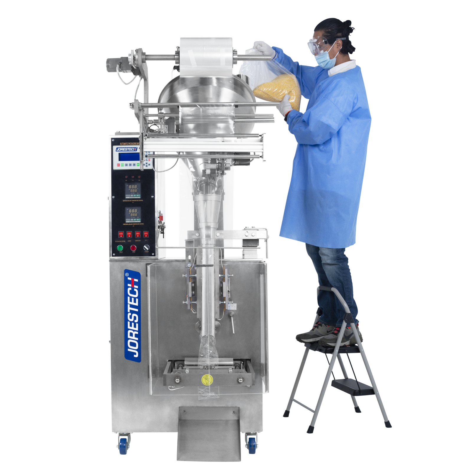 Operator emptying a clear bag with a yellow granulated powder into the hopper of a VFFS packaging system for powdered products. He is standing on a ladder to have proper access to the machine's feeding area. 