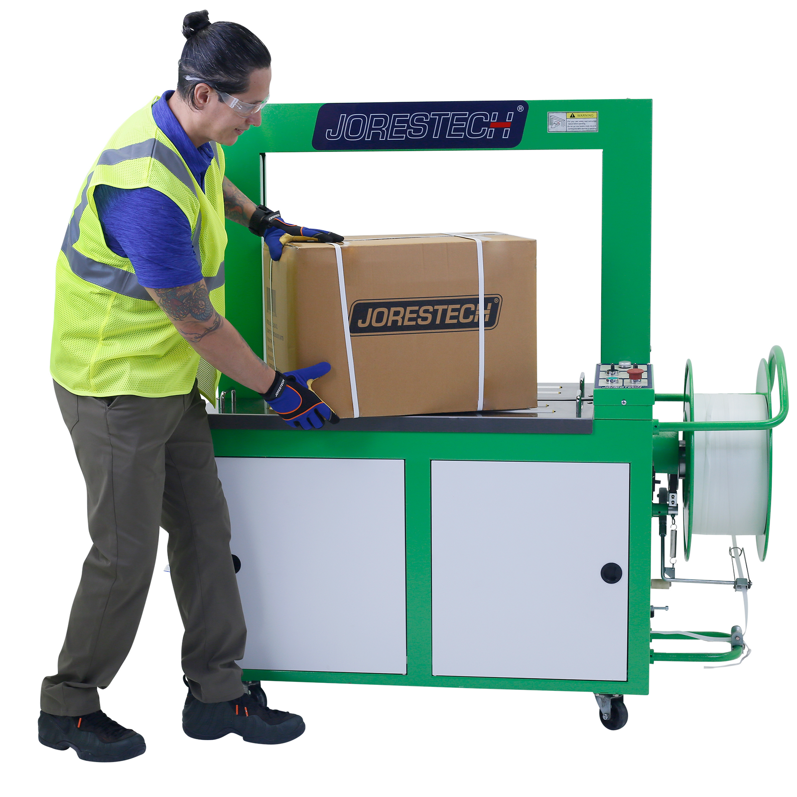 A worker removing a strapped card box from a JORES TECHNOLOGIES® automatic poly strapping machine