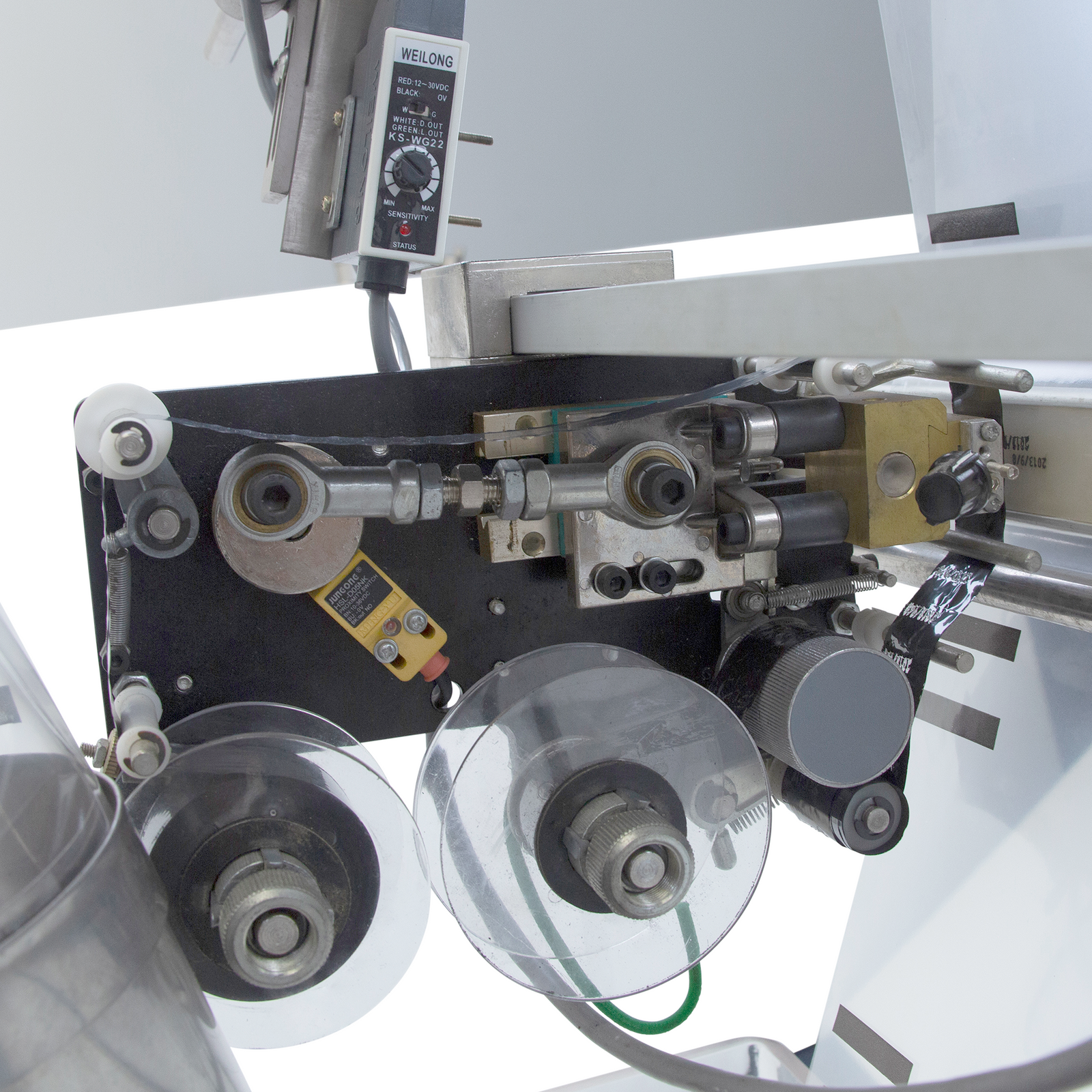 Close-up of the hot-stamp coder printer on a VFFS packaging machine for powdered and bulk products.