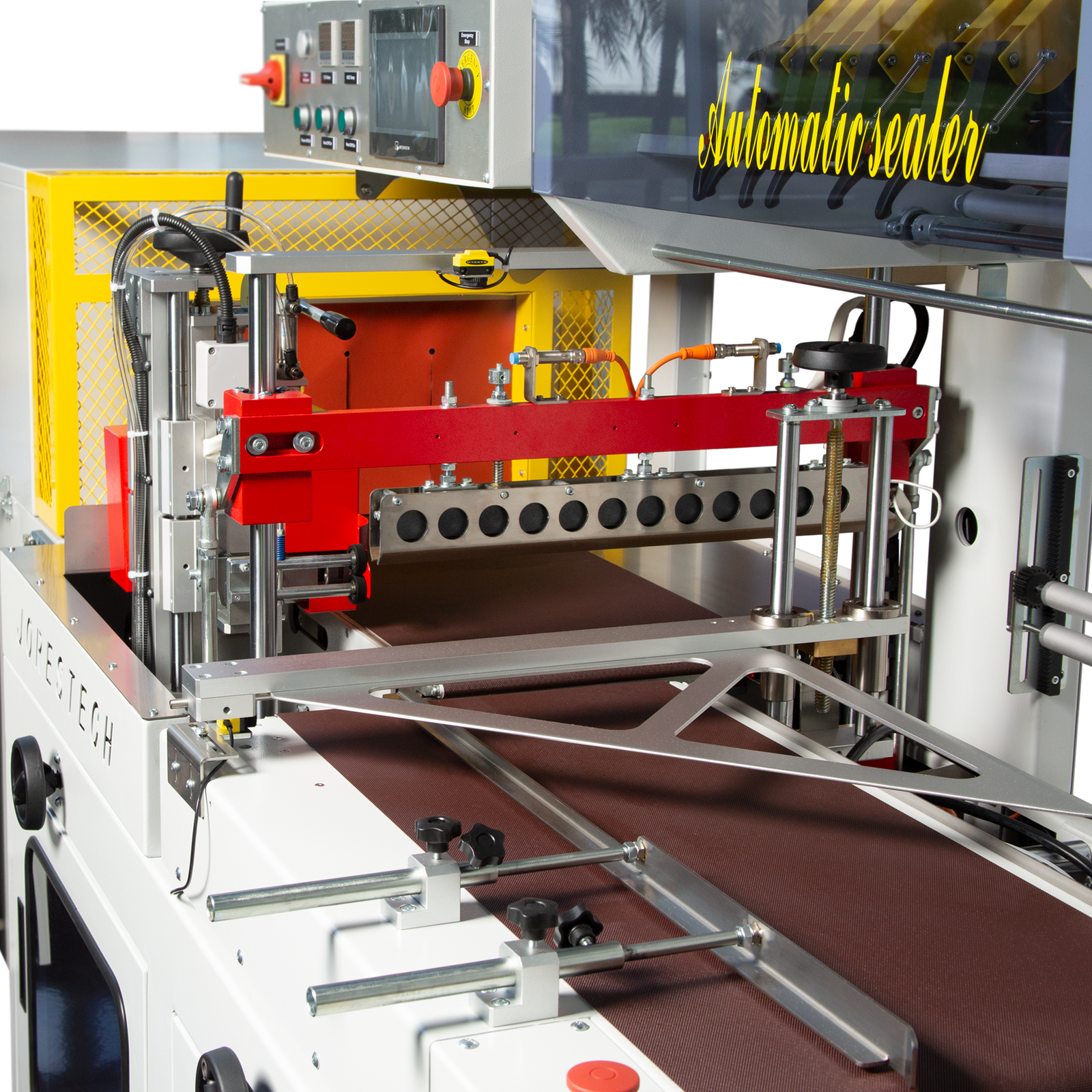 Detail shows, the entry conveyor, the pneumatic seal mechanism, the control panel, of the side sealer and the entry of the shrink tunnel positioned at the end of the side sealer.