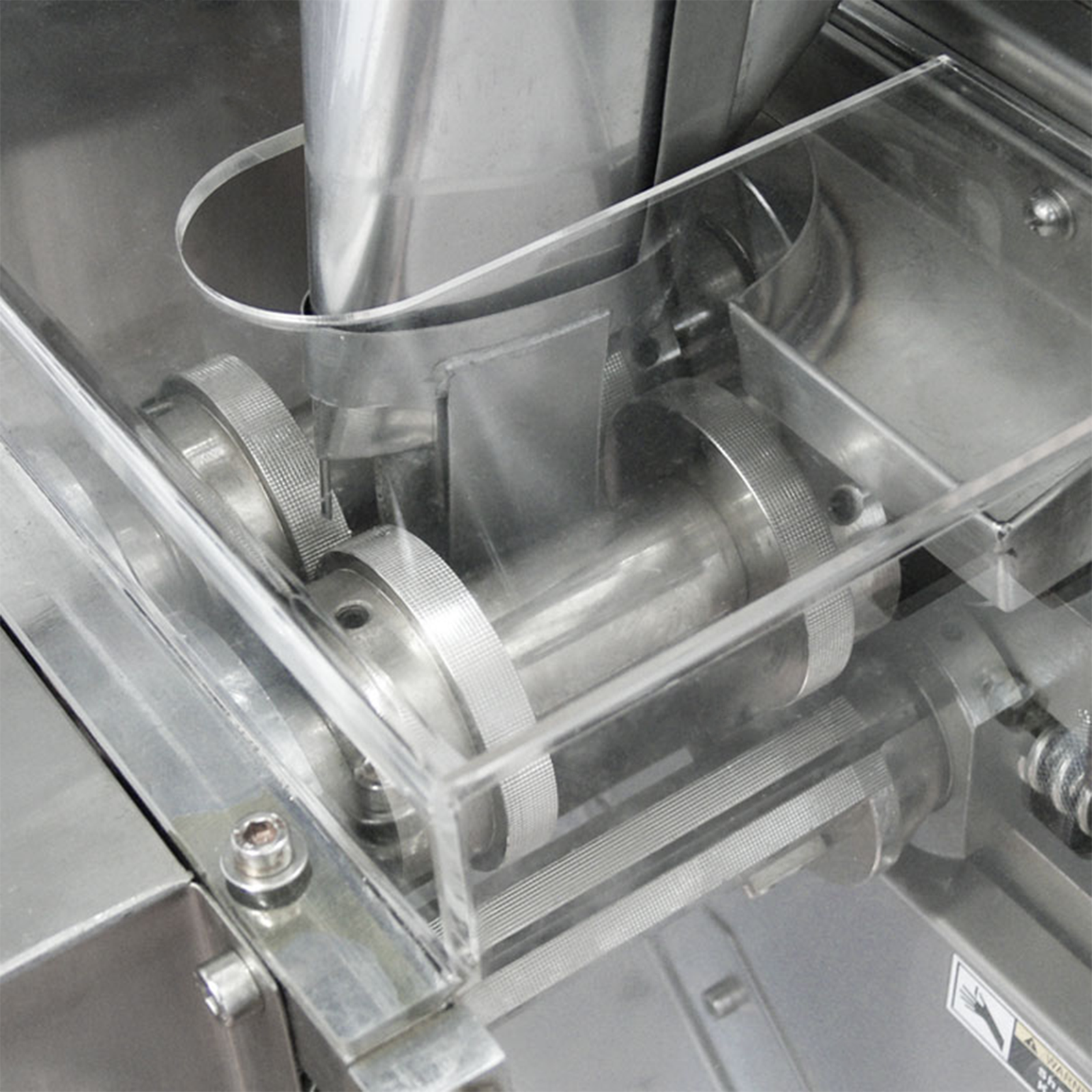 Detail shot of the stainless steel sachet bag shaper and former on a jorestech VFFS packaging system for grains and granulates. 