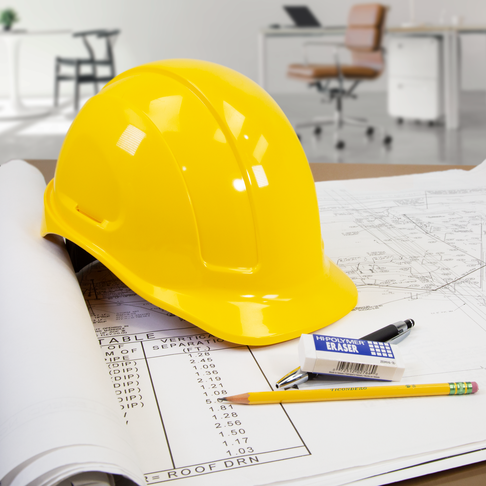 Features an office and a detailed shot of the yellow jorestech cap style hard hat on a table over some blueprints