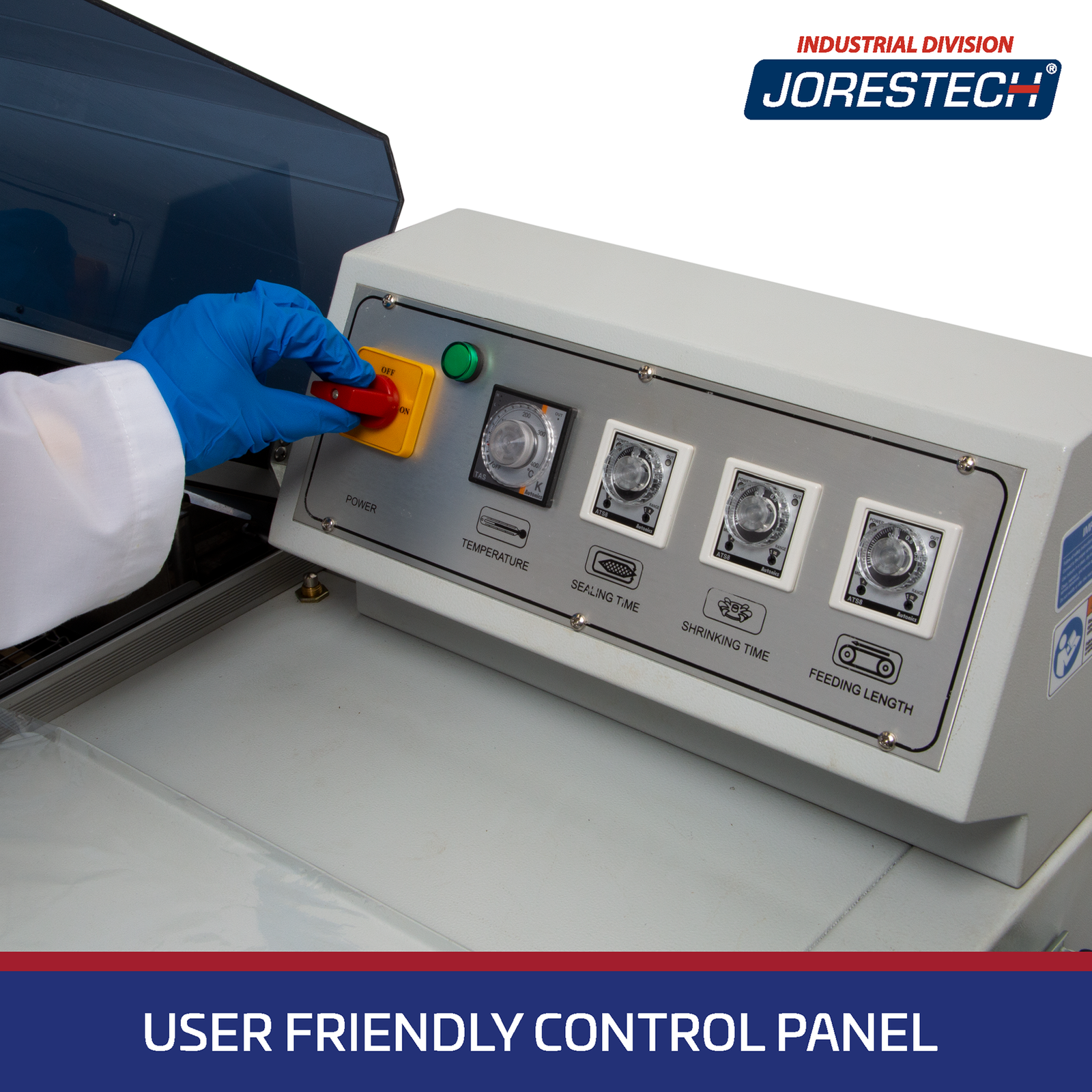 Close-up detail shot of the control panel on a JORES TECHNOLOGIES® Chamber style Shrink Wrapping Machine. A hand wearing a blue glove is turning the ON / OFF switch. Control panel shows temperature control, sealing time and shrinking time twist knobs. Blue banner says: User Friendly Control Panel.