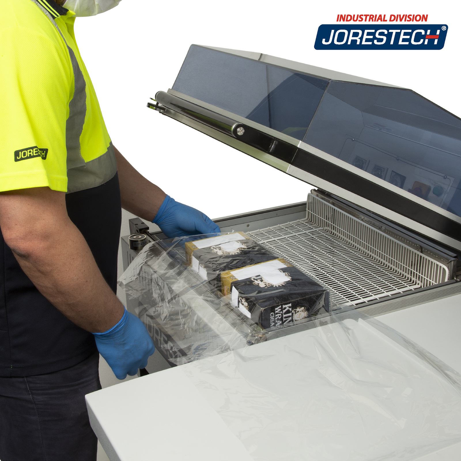 Person wearing a high visibility yellow shirt using a shrink packaging all in one system to package a bundle of boxes.