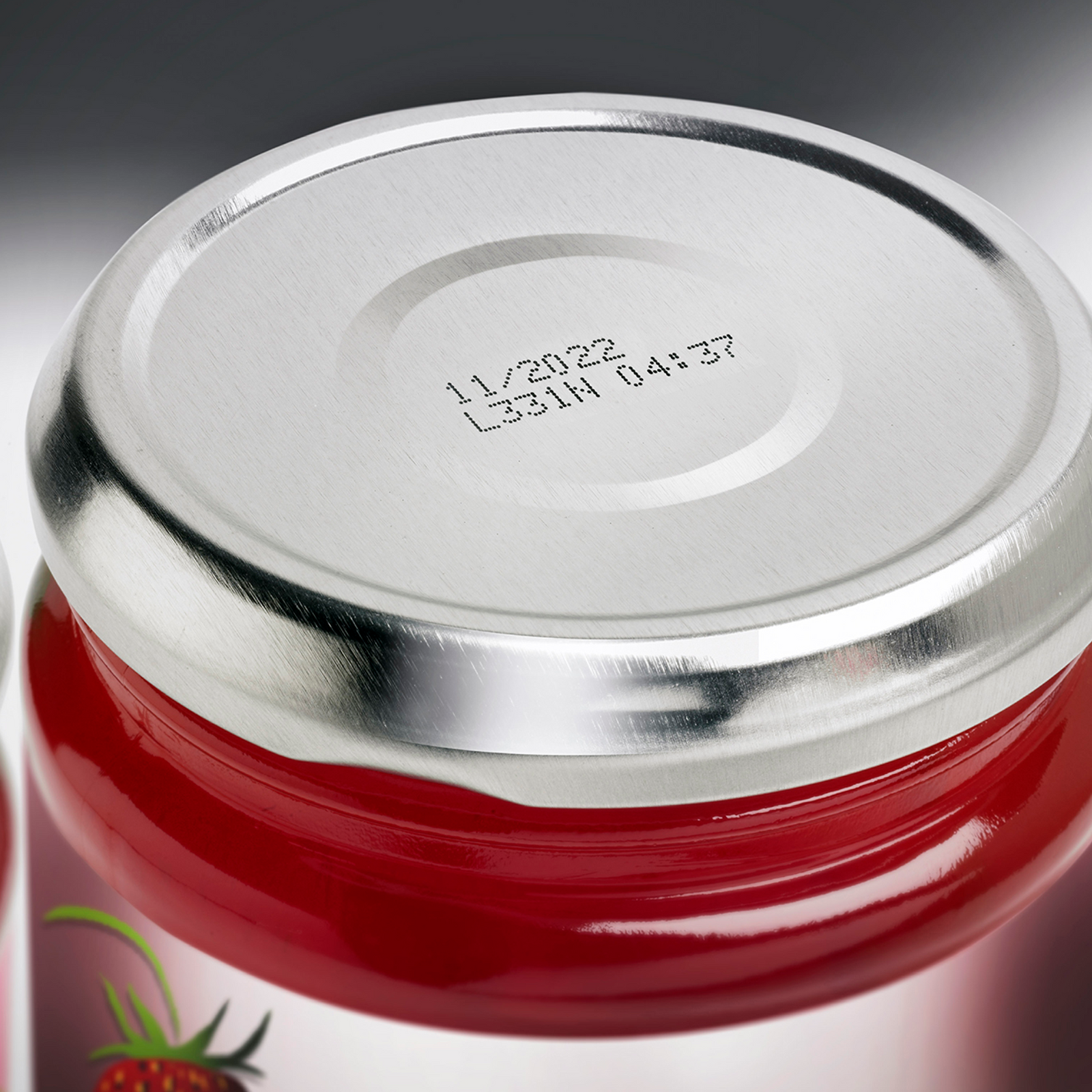 Metal lid of a jam container printed with date and time by an Inkjet LINX coder