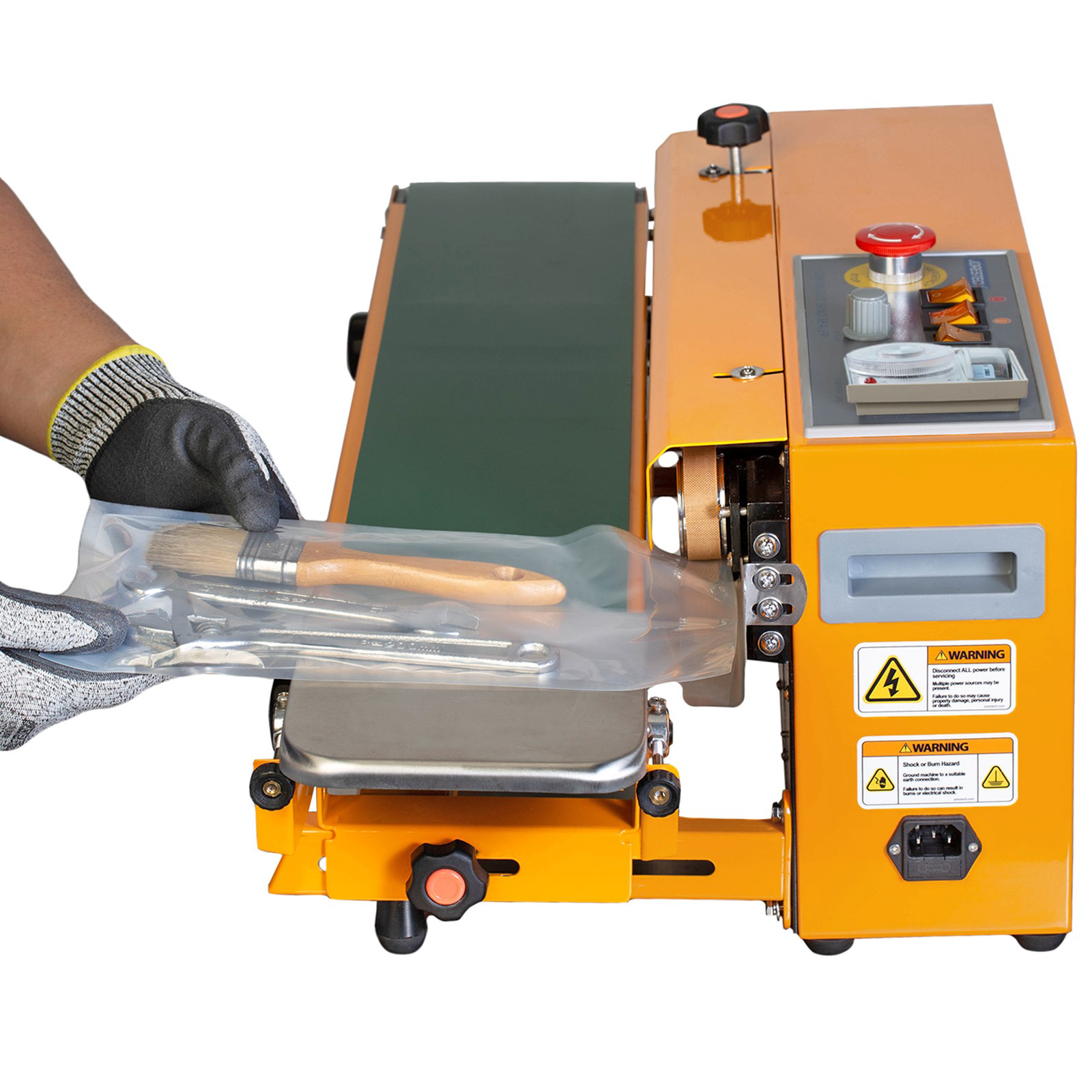 operator inserting  a bag with tools in the sealing element in horizontal continuous band sealer