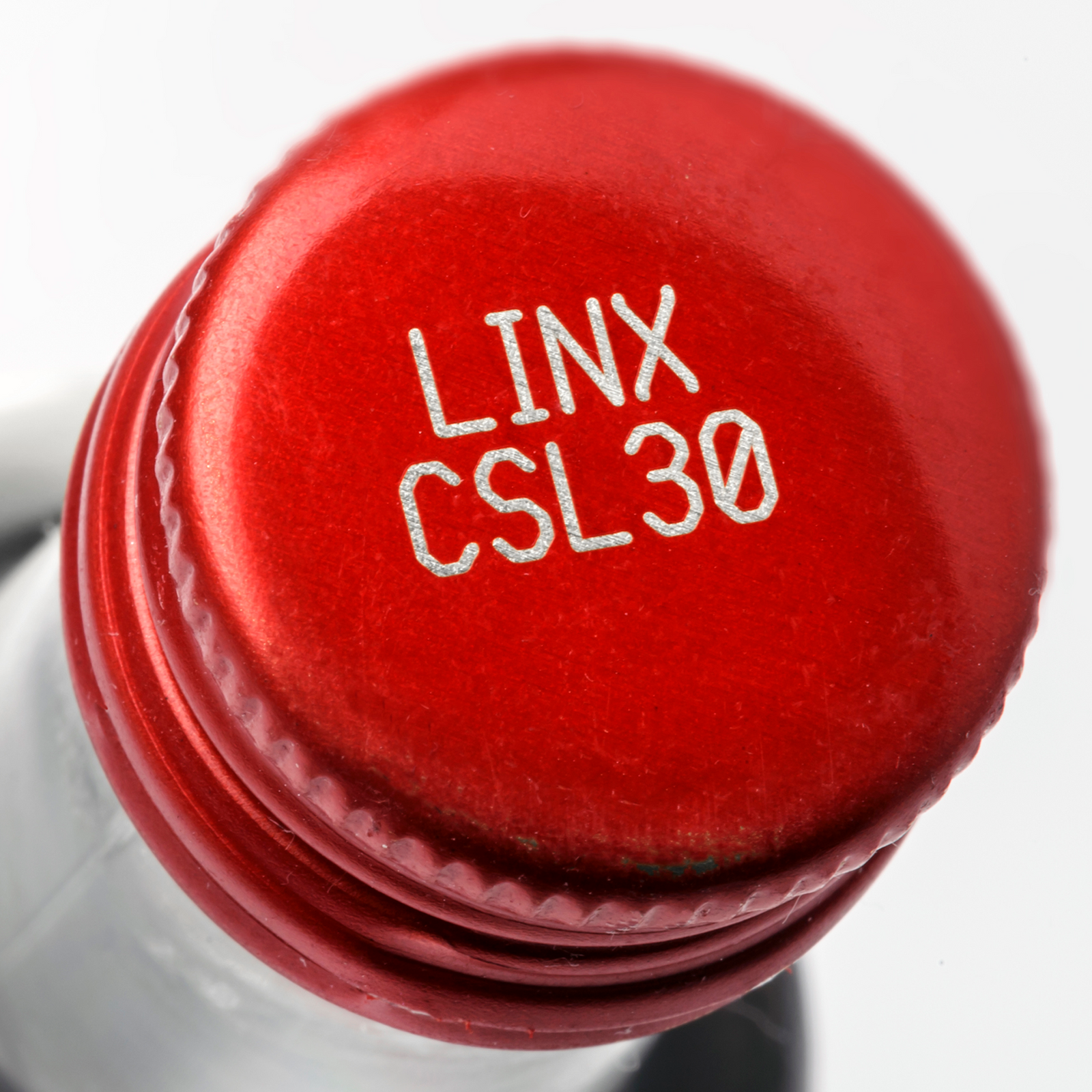 Clear glass bottle with a red metal cap marked with a code done with a CSL30 laser coder
