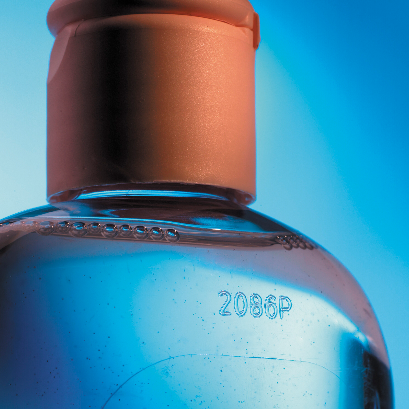 Code marked on a glass bottle done by a CSL60 LINX laser coder