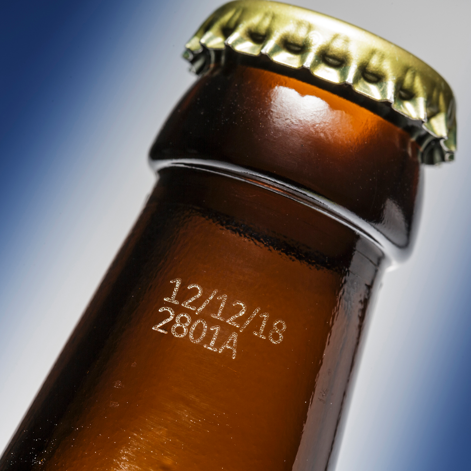 Code marked on a glass bottle done by a CSL60 LINX laser coder