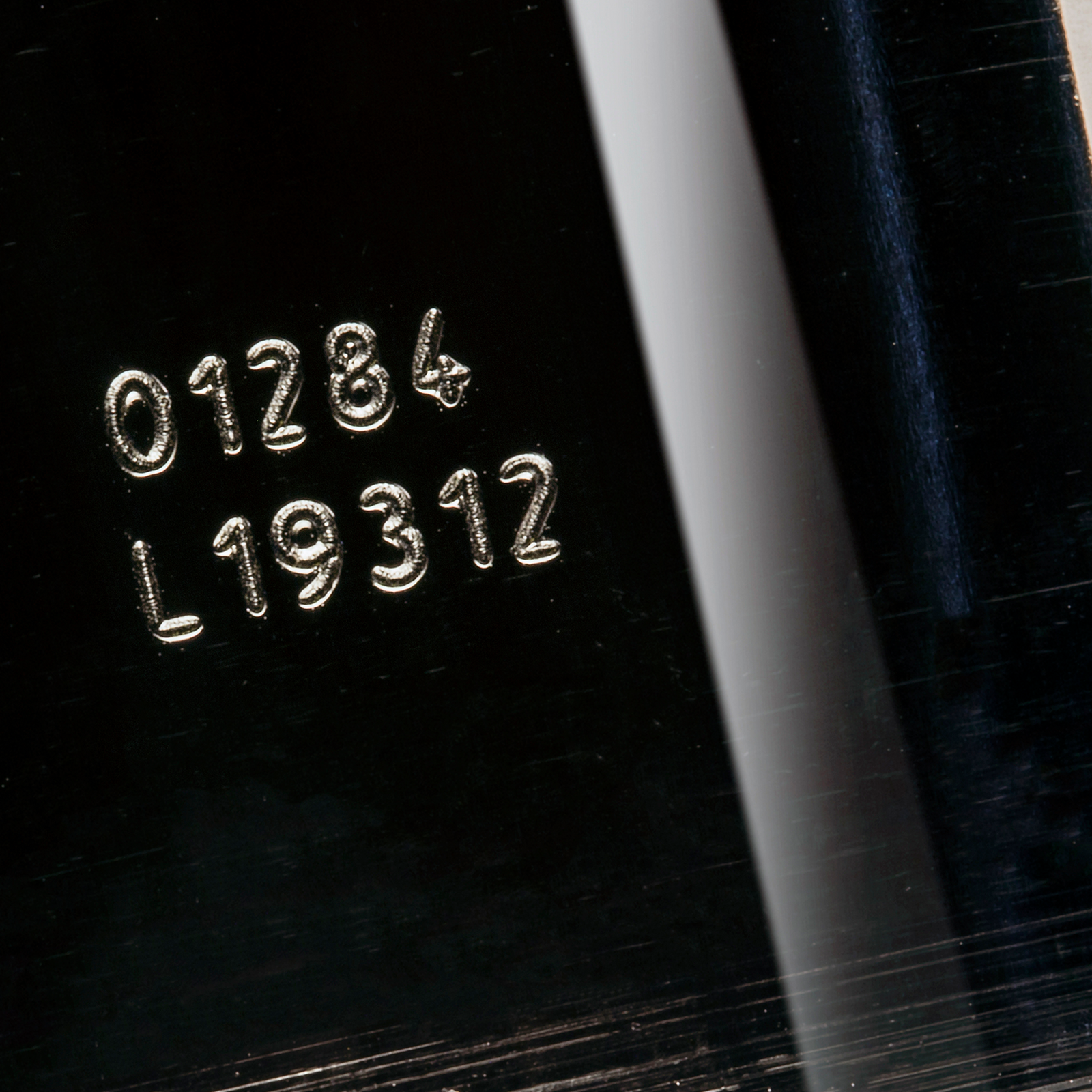 Code printed on a glass bottle done by a CSL60 LINX laser coder