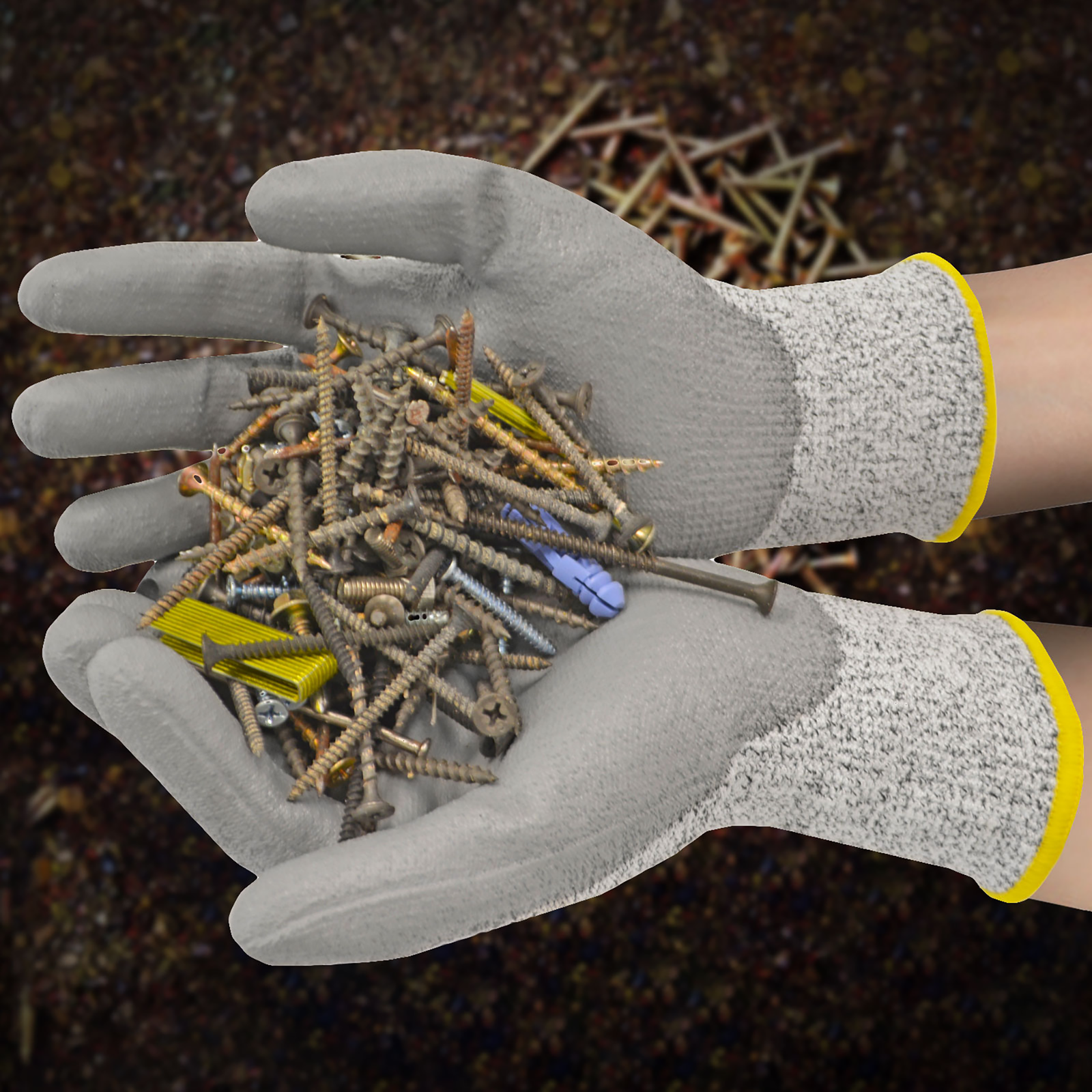 Person wearing the JORESTECH cut resistant gray safety work gloves with polyurethane dipped palm holding nails and staples. 