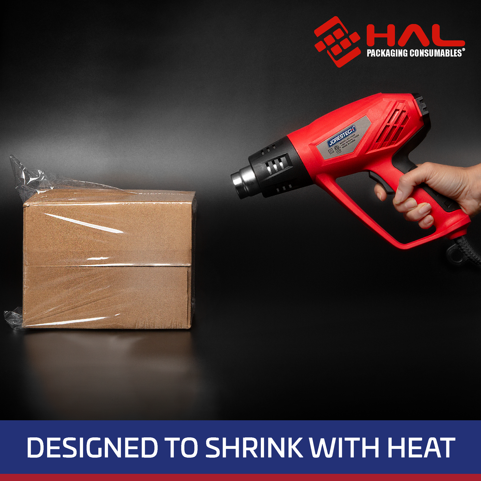 Box being sealed with shrink wrapping plastic over a black background. Half of the film on the box has been shrunken around the box while the other half remains loose. A person is holding a heat gun pointing it towards the box on the side where the film has already shrunk. Blue and white text on the bottom says Designed to Shrink with Heat.