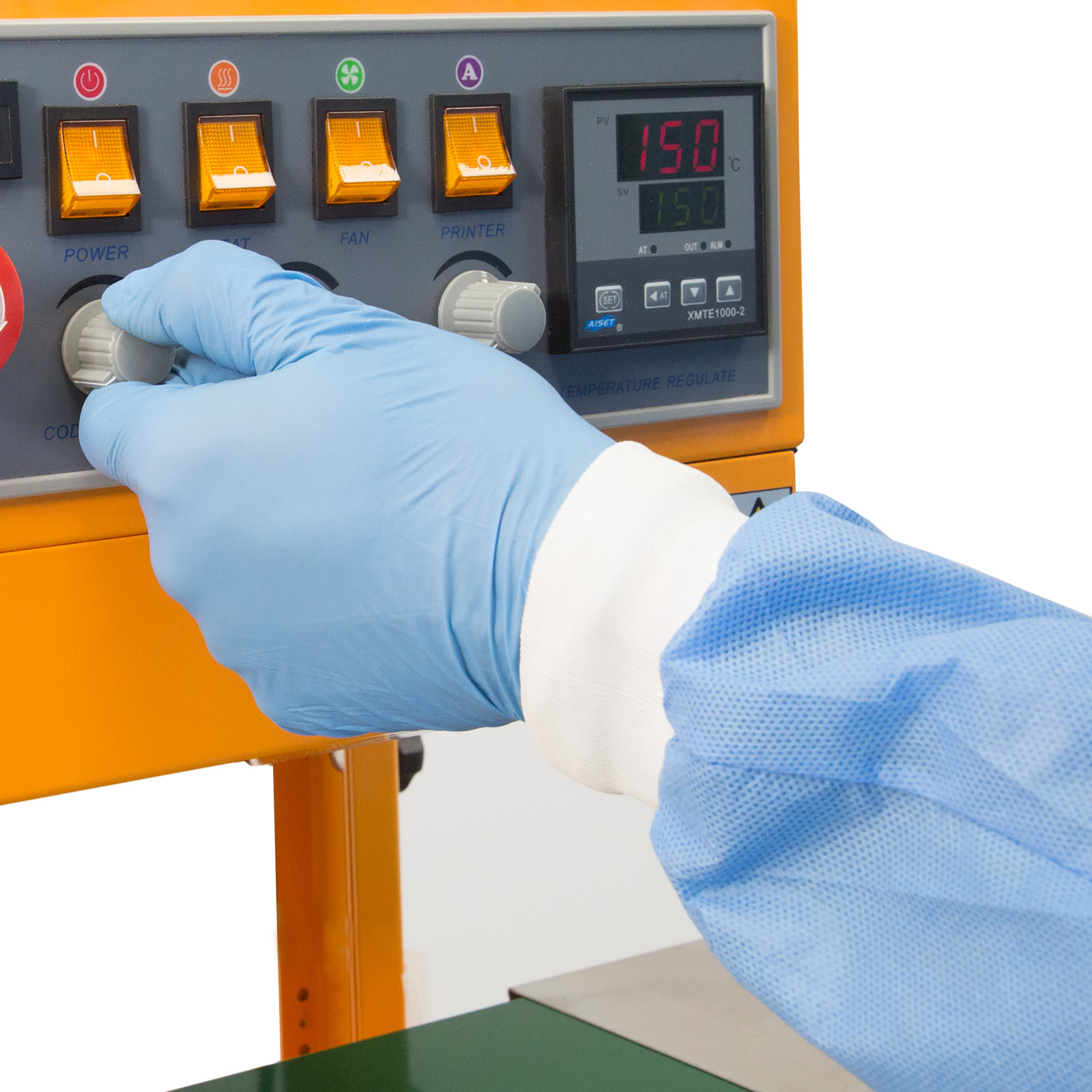 operator wearing blue gloves adjusting dial on control panel of the JORES TECHNOLOGIES® continuous band sealer 