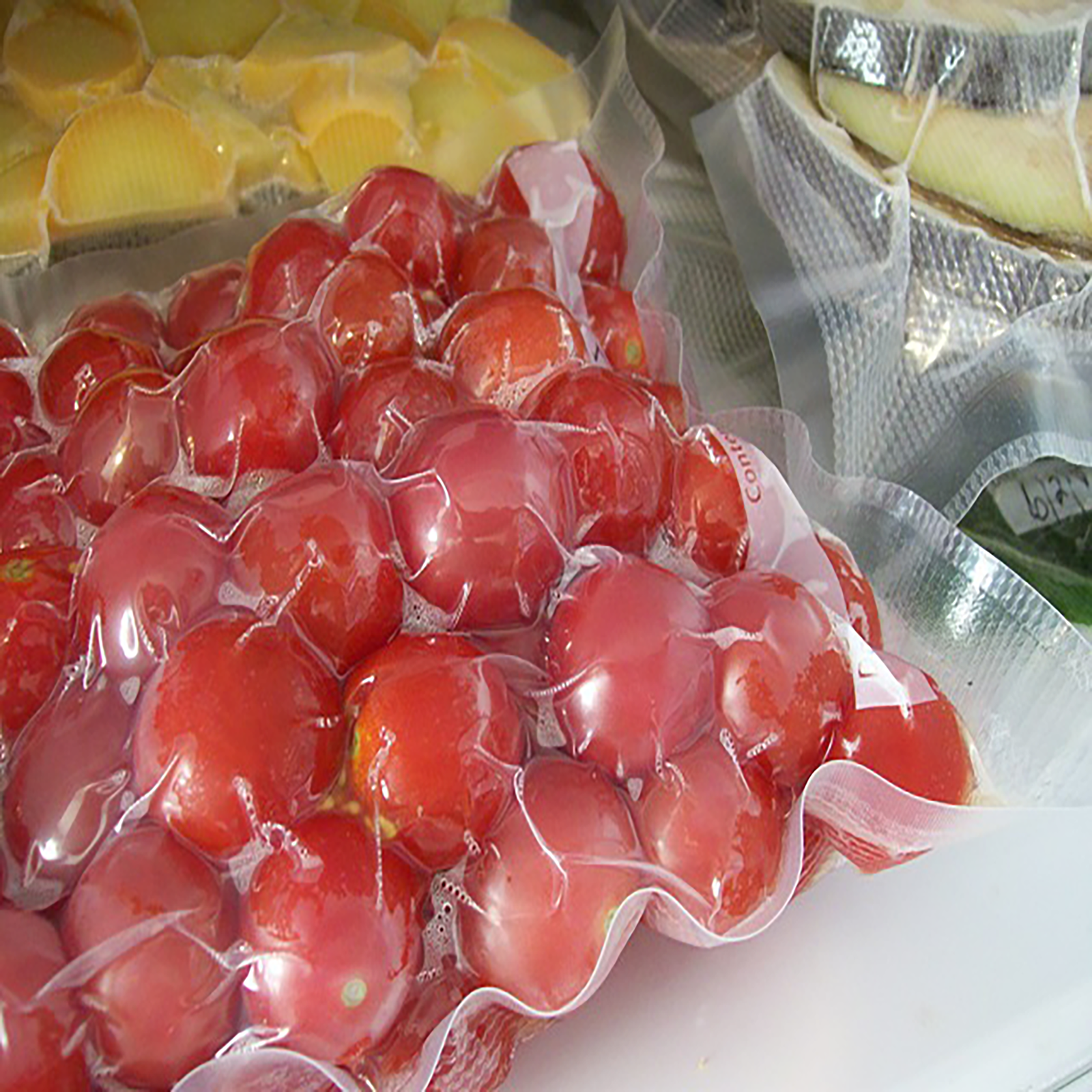 Different red, green and yellow vegetables vacuumed sealed in a JORESTECH embosses vacuum sealer bag