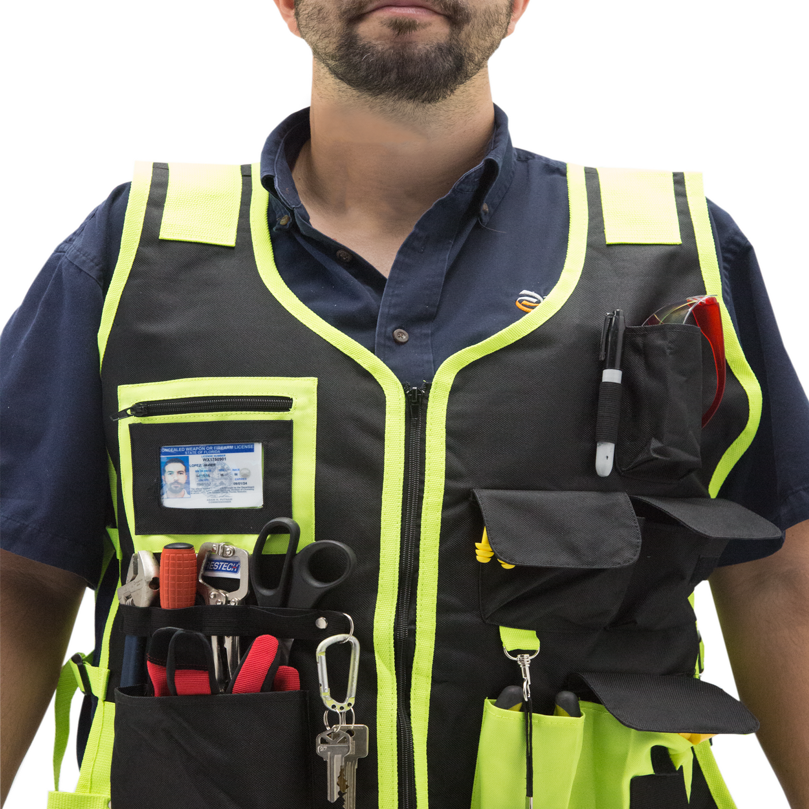 Worker wearing a JORESTECH tool vest filled with items like, keys, screw drivers, pliers, scissors, pens, gloves, glasses, etc.