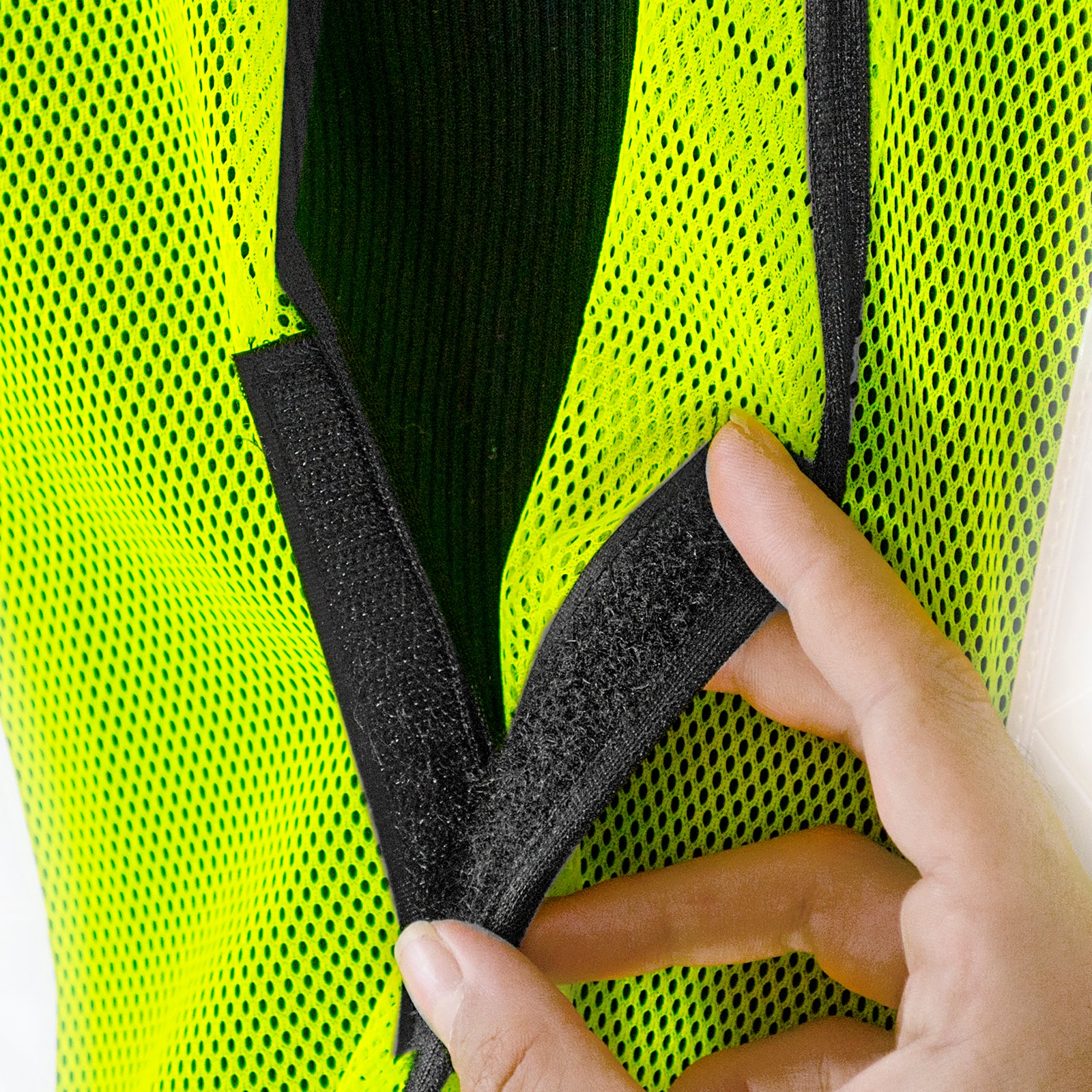 Close-up shows the hook and loop fastener system of the hi visibility safety vest with prismatic stripes