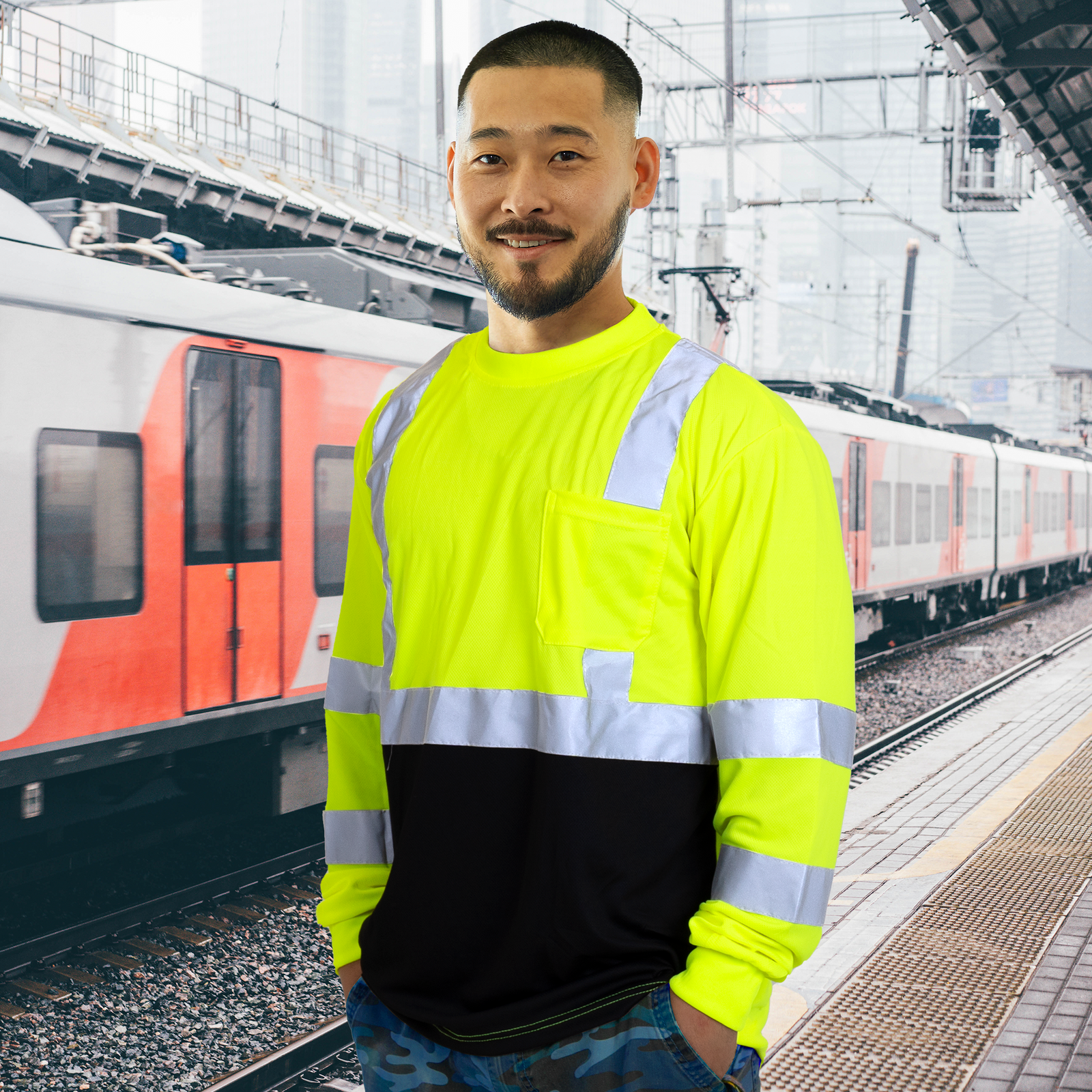 Worker in a train station wearing high vis reflective dirt concealing safety long sleeve shirt