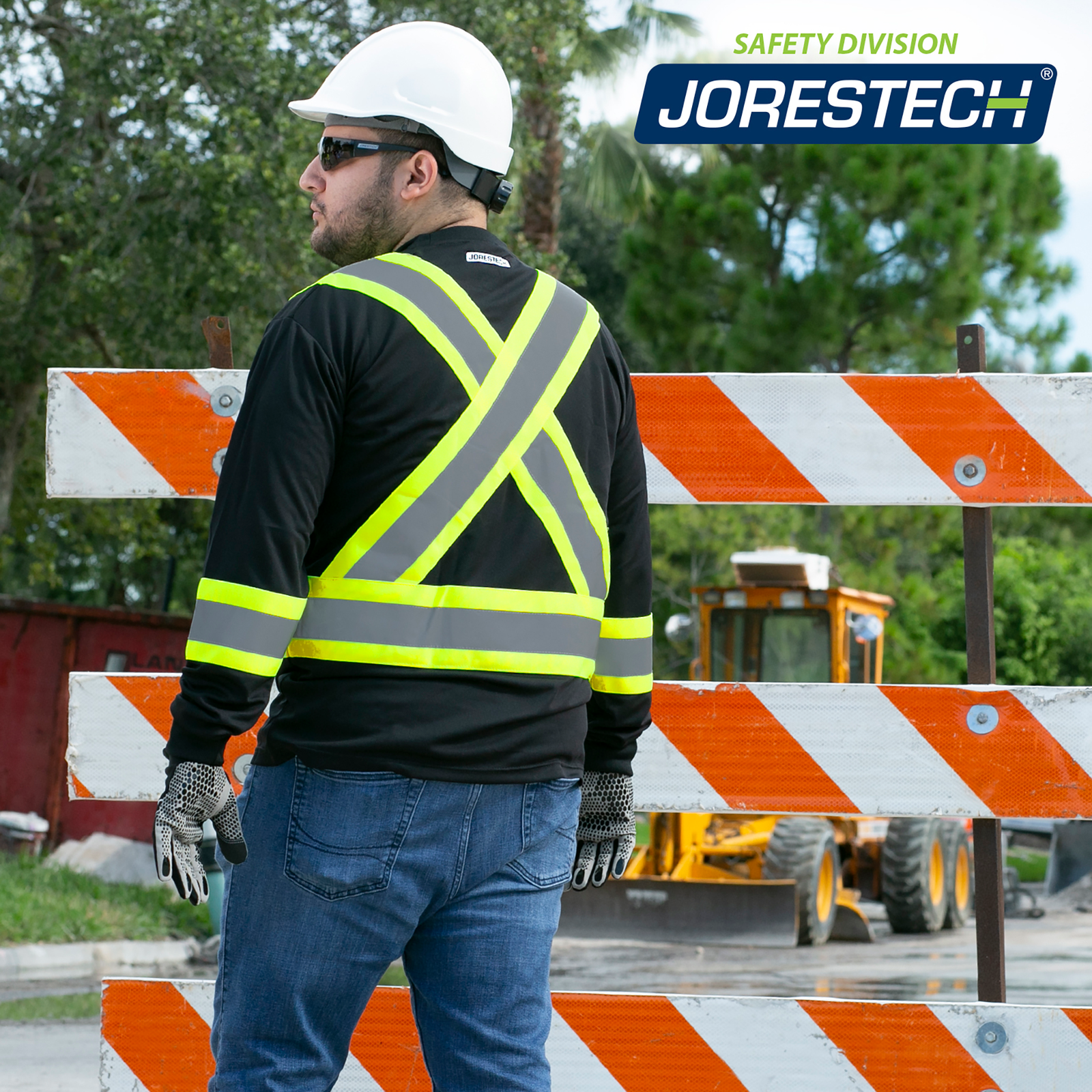 A worker wearing black and yellow JORESTECH® safety shirt with X on back ANSI and CSA compliant and birds eye safety shirt.
