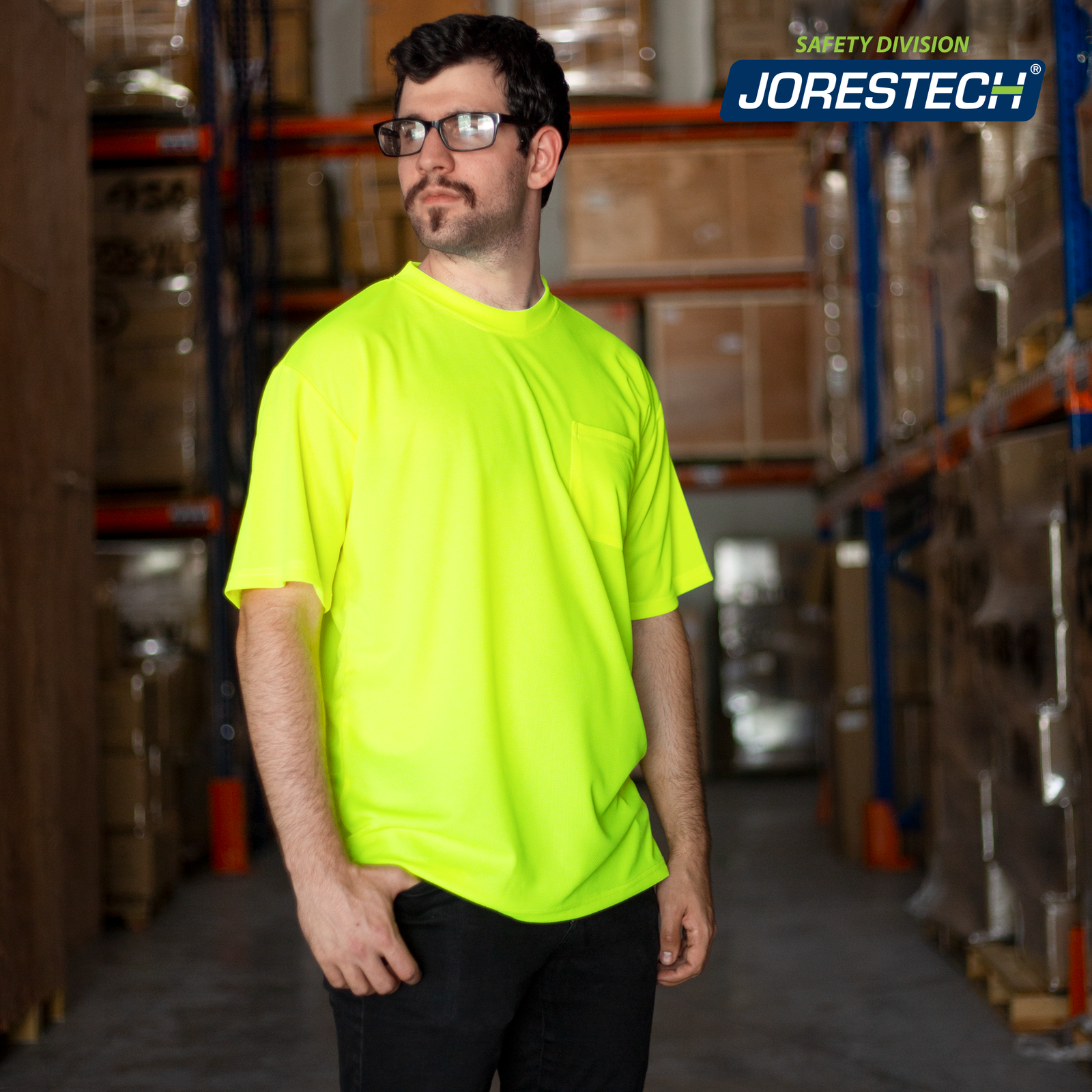 Man wearing the JORESTECH hi-vis Yellow/Lime safety shirt  inside a warehouse filled with brown boxes