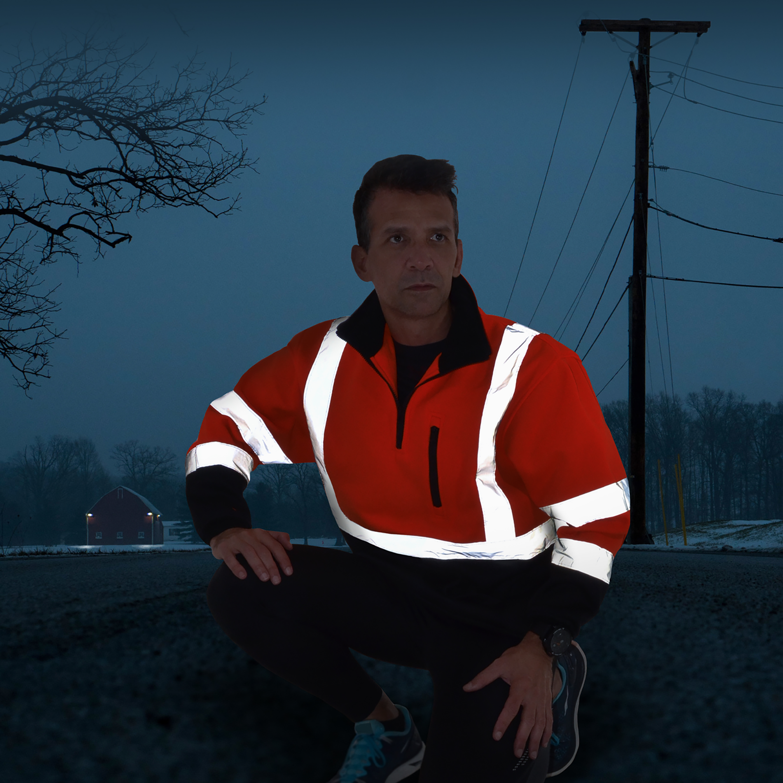A man wearing the hi-vis JORESTECH safety sweater during night time showing the light reflective on the reflective stripes to increase visibility. 