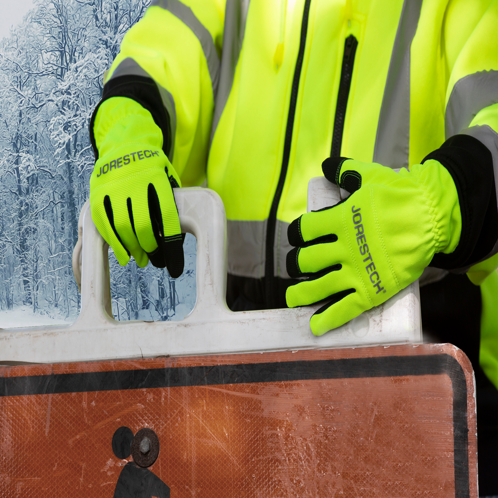 Person wearing the JORESTECH hi-vis safety gloves to move a street caution sign from one place the the other in a winter setting for road construction