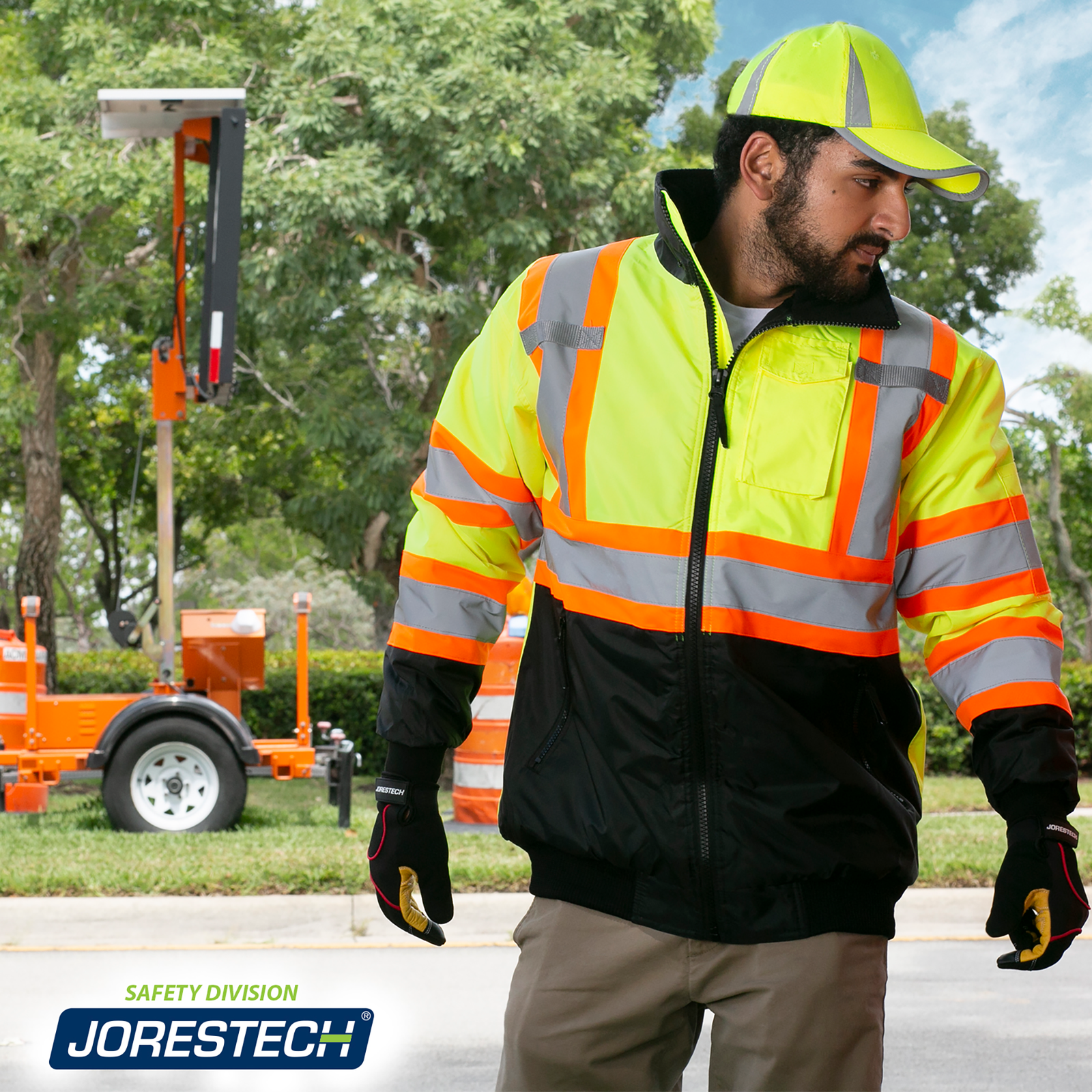 Worker wearing the two tone reflective JORESTECH waterproof safety jacket in a construction site on the street