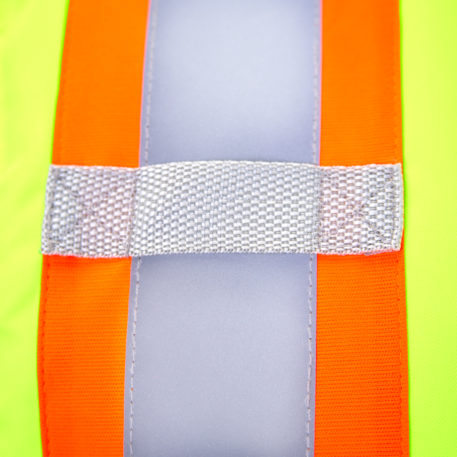 Close up of the insulated safety vest with radio tab, the reflective material and the orange contrasting fluorescent strips