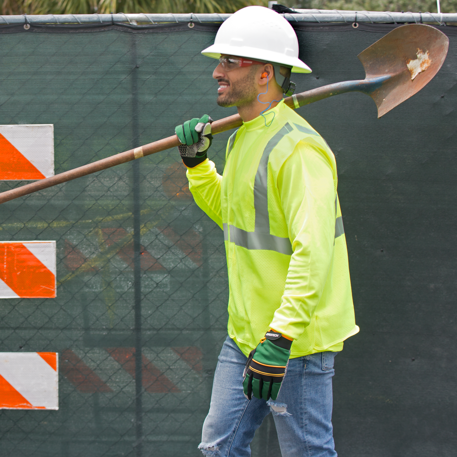 A worker wearing the Jorestech yellow mesh tearaway safety vest for road construction