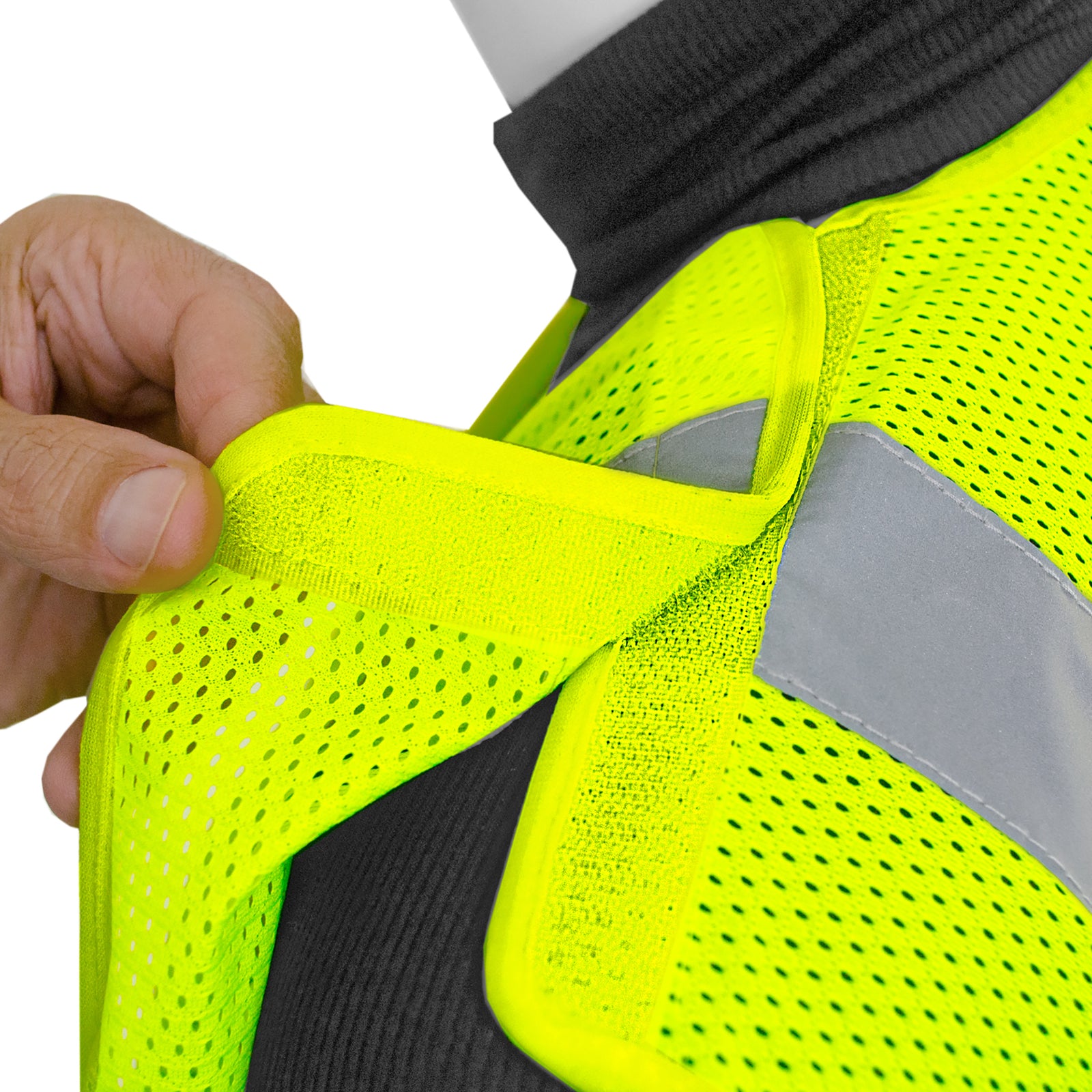 Close-up to show the size of the bright lime mesh material and the hook and loop located in the shoulder closure