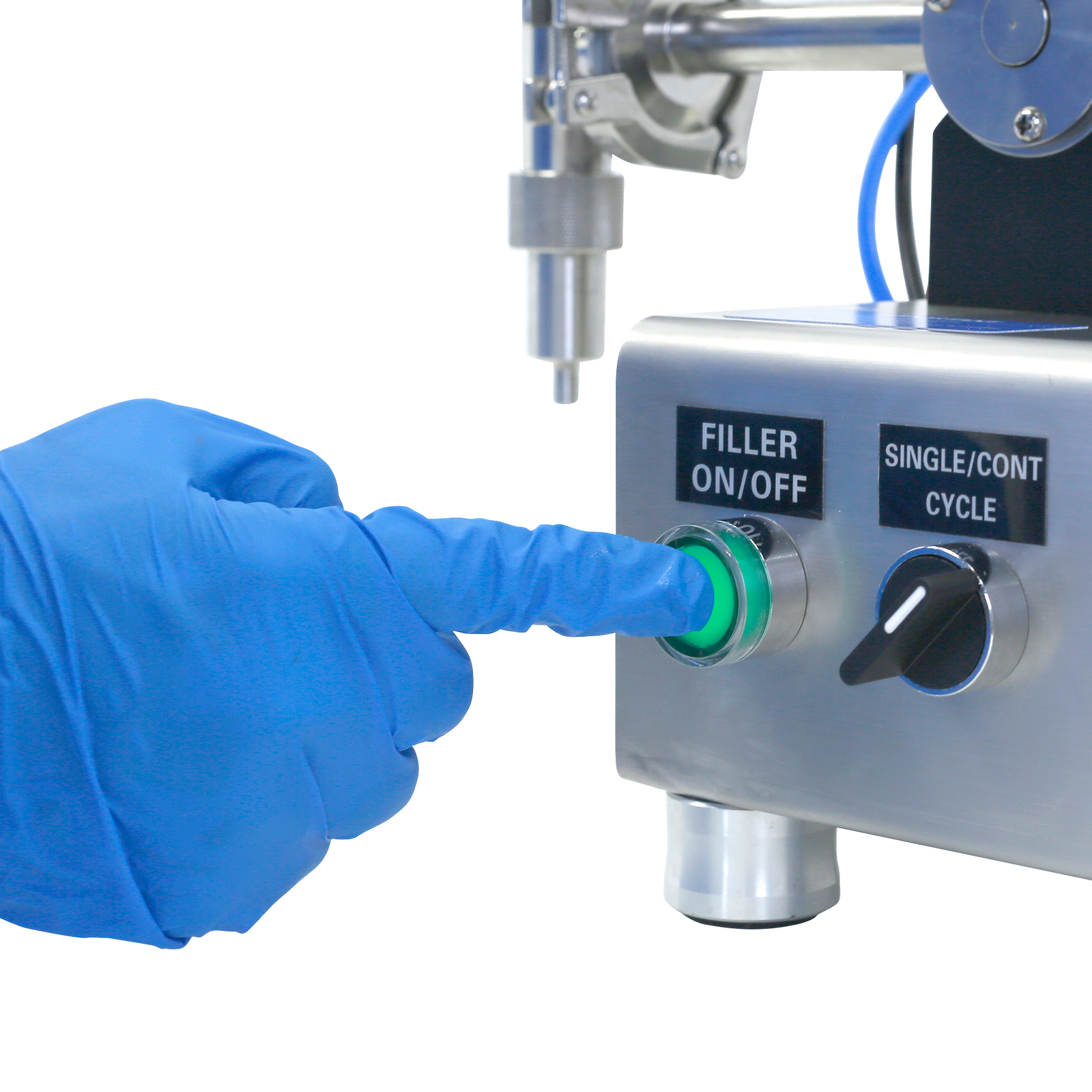 Close up of a person wearing nitrile blue gloves pressing the on/off switch of the JORESTECH table top piston filler for paste