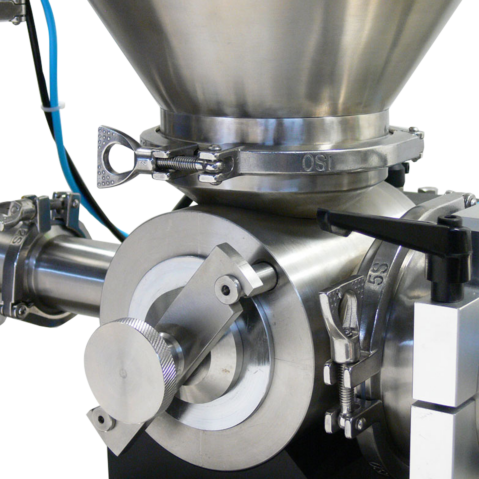 Close shows detail of the rotary valve of the JORES TECHNOLOGIES® Volumetric Piston filler and also detail of the base of the hopper and clamp