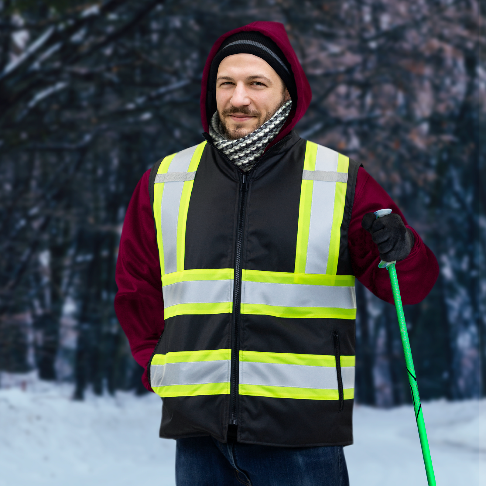 A man wering the two tone black and yellow insulated safety vest for winter