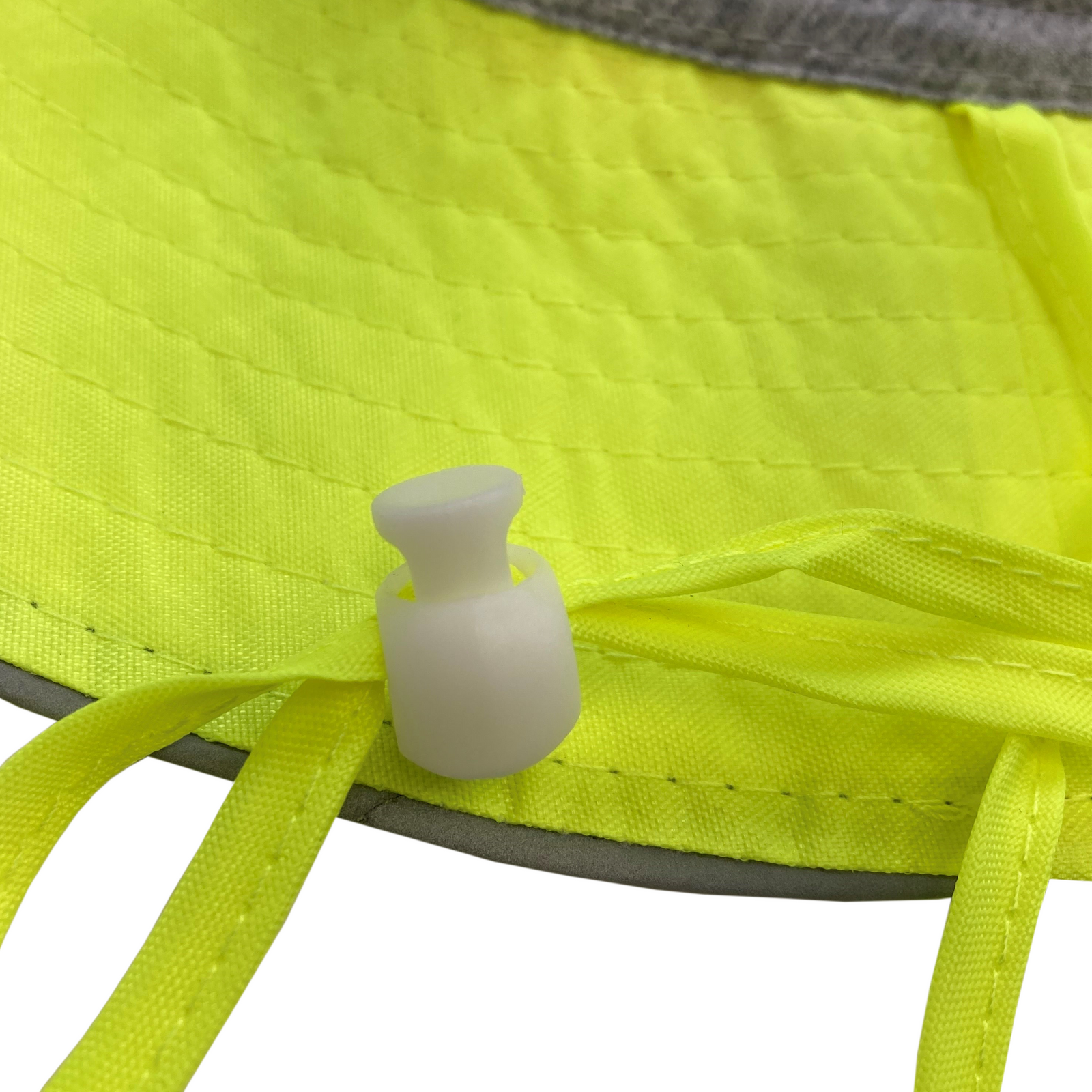 Close up to show the adjustable strap on the lime safety reflective boonie hat
