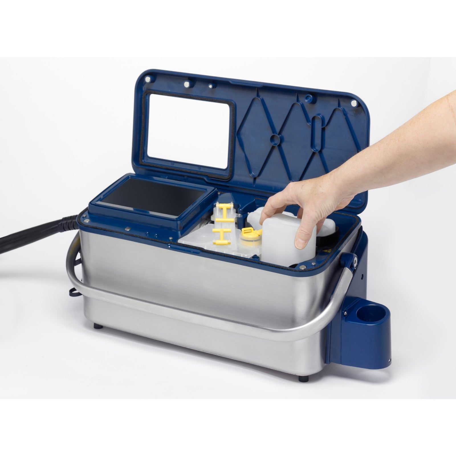 A person replacing the back ink container of a LINX 10 Ink Jet Printer and coder