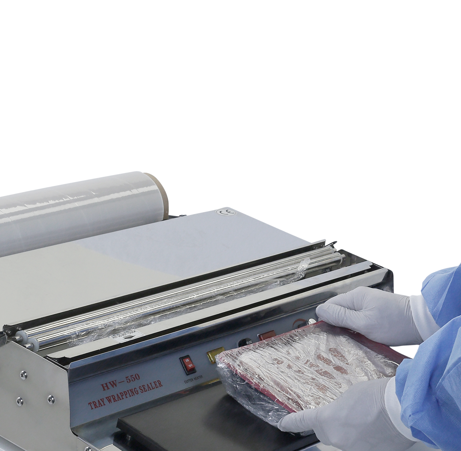 operator wearing white gloves shrink wrapping food tray using manual tray wrapper