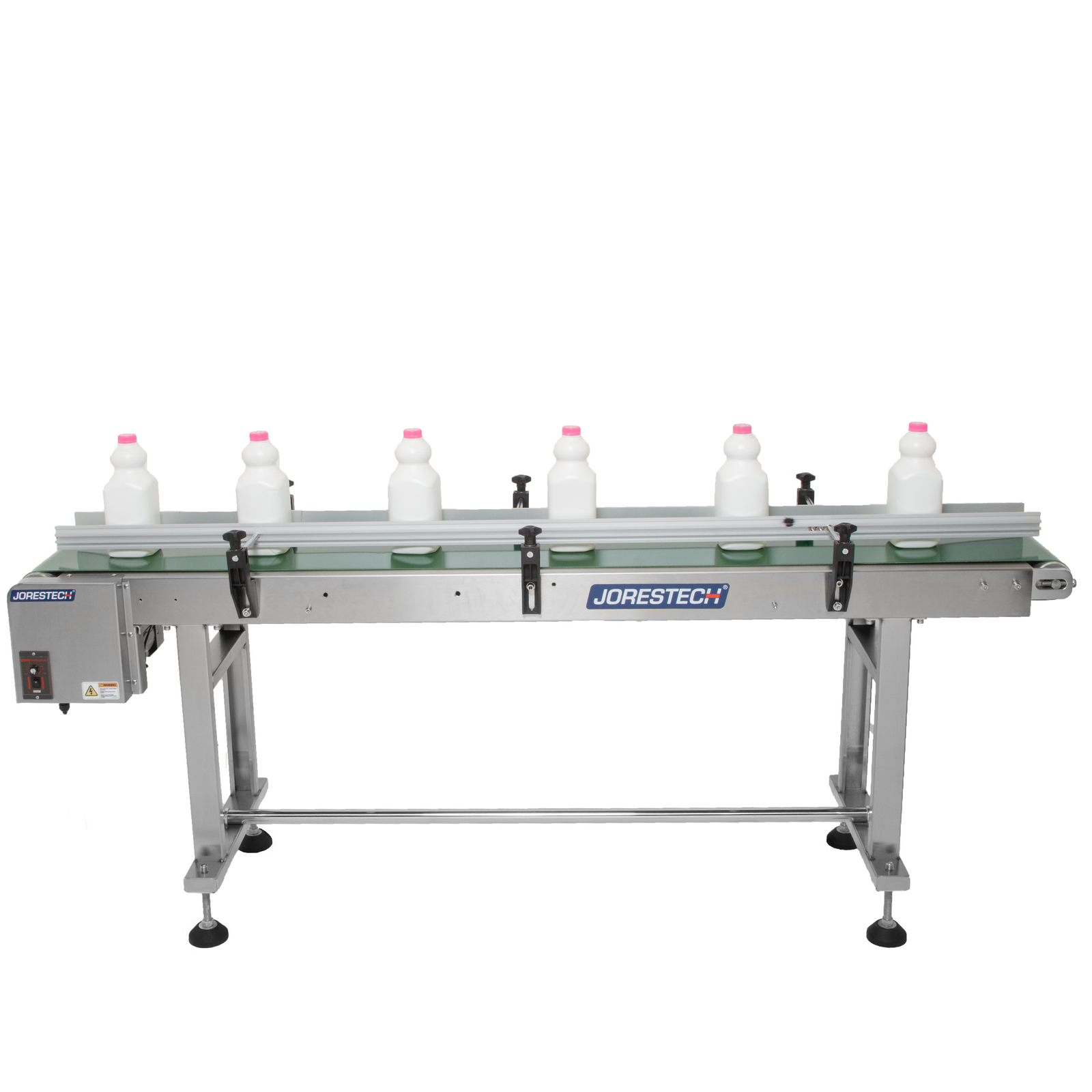 white milk bottles with pink tops on motorized conveyor with steel frame and green belt that features side guard rails.