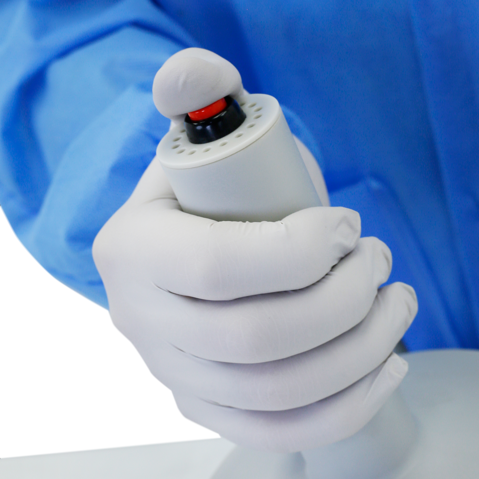 Head of the induction sealer. A person is pressing the trigger knob in order to activate cap sealer