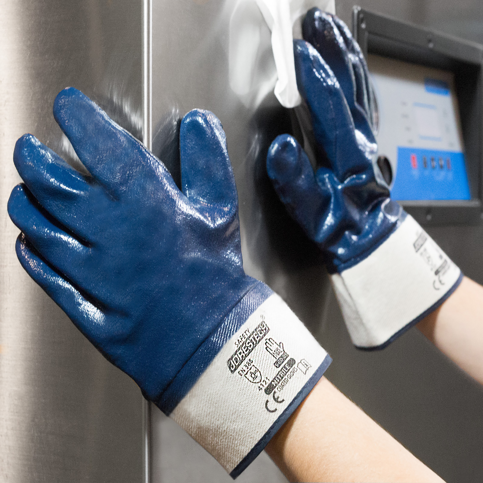 Worker cleaning a stainless steel machine with the nitrile coated safety work gloves