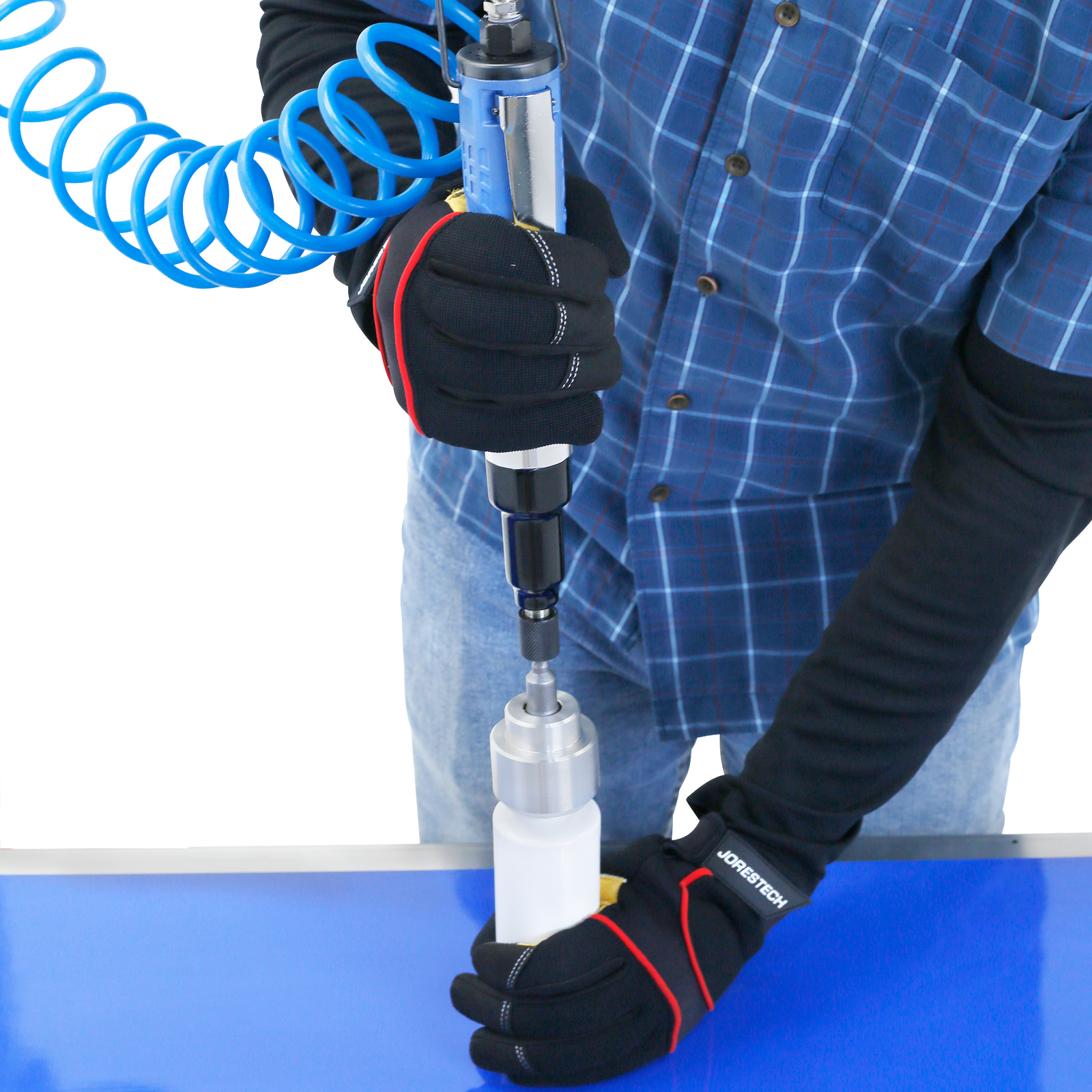 man wearing blue striped shirt and jeans and black gloves capping white bottles using manual bottle capper
