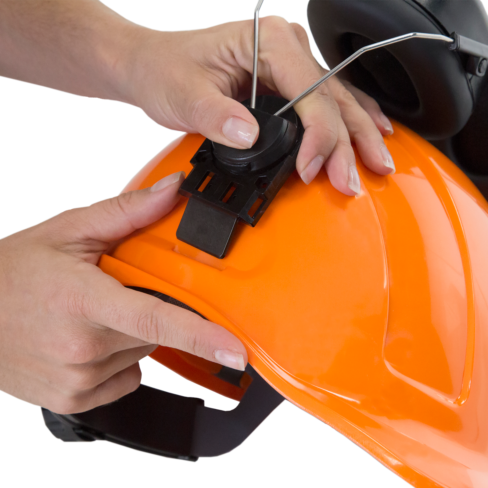 Close-up of the hands of a person placing the black JORESTECH ear muffs inside the universal style slots of an orange cap style JORESTECH ANSI compliant hard hart over white background