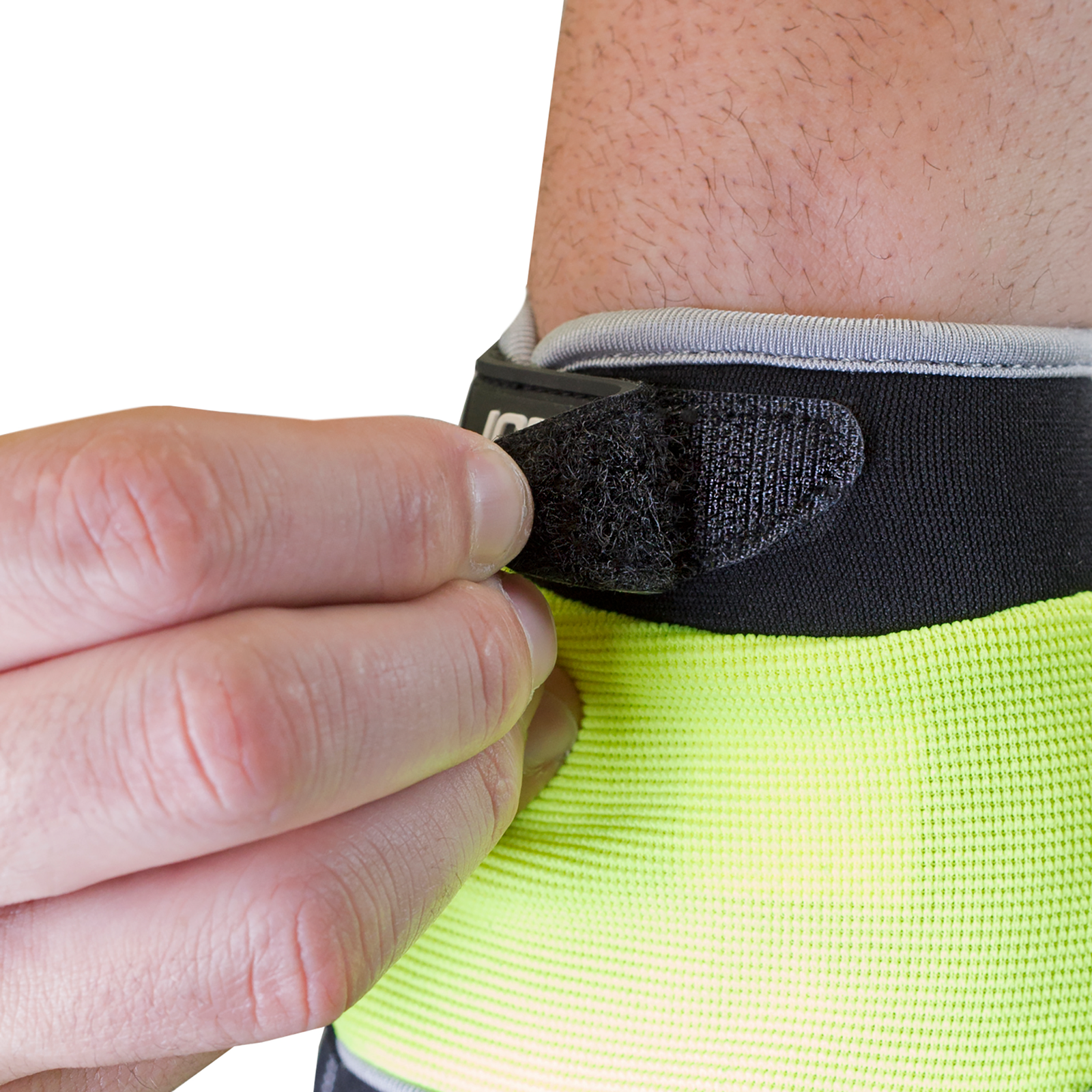 Close up of the hook and loop closure system of the lime JORESTECH safety work glove with anti slip silicone black dotted palms