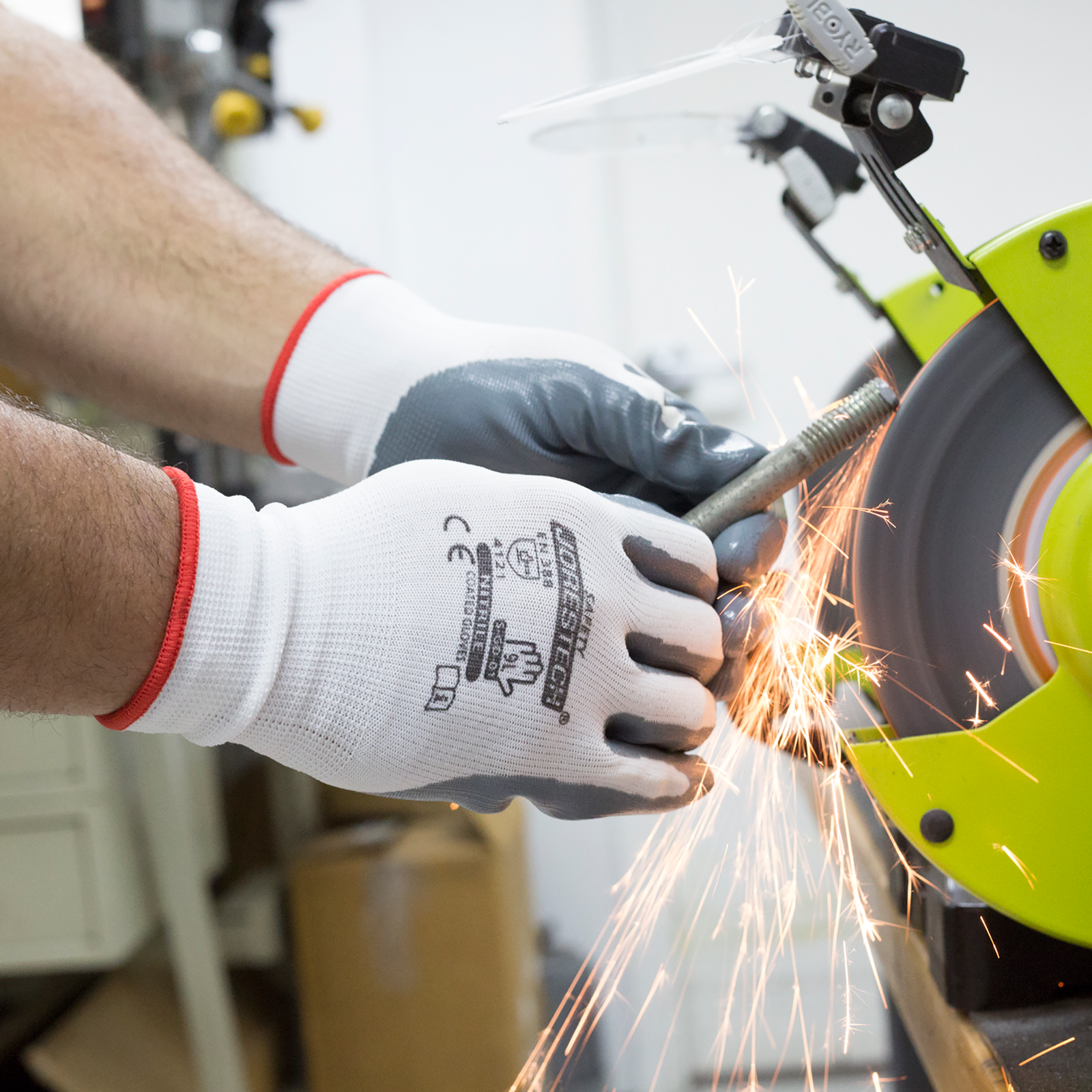Worker using the JORESTECH safety work gloves with nitrile dipped palms while doing a DYI project with power tools